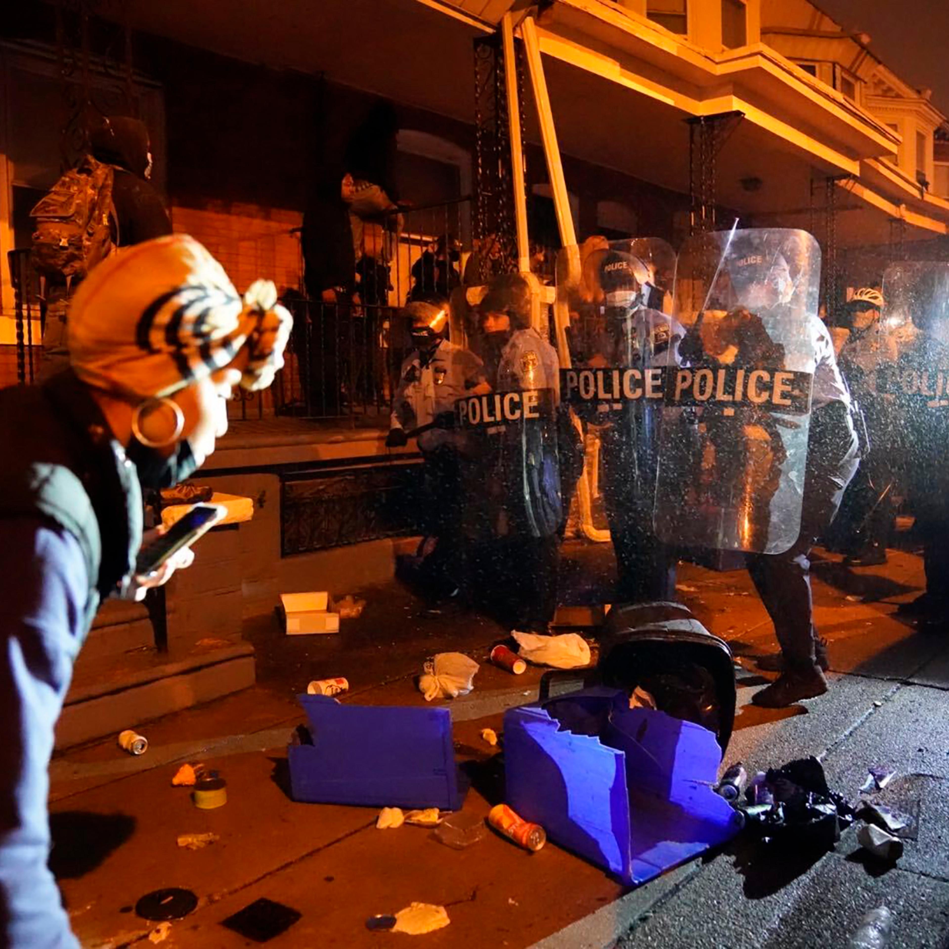 Police officers move in formation during a protest in response to the police shooting of Walter Wallace Jr., Monday, Oct. 26, 2020, in Philadelphia