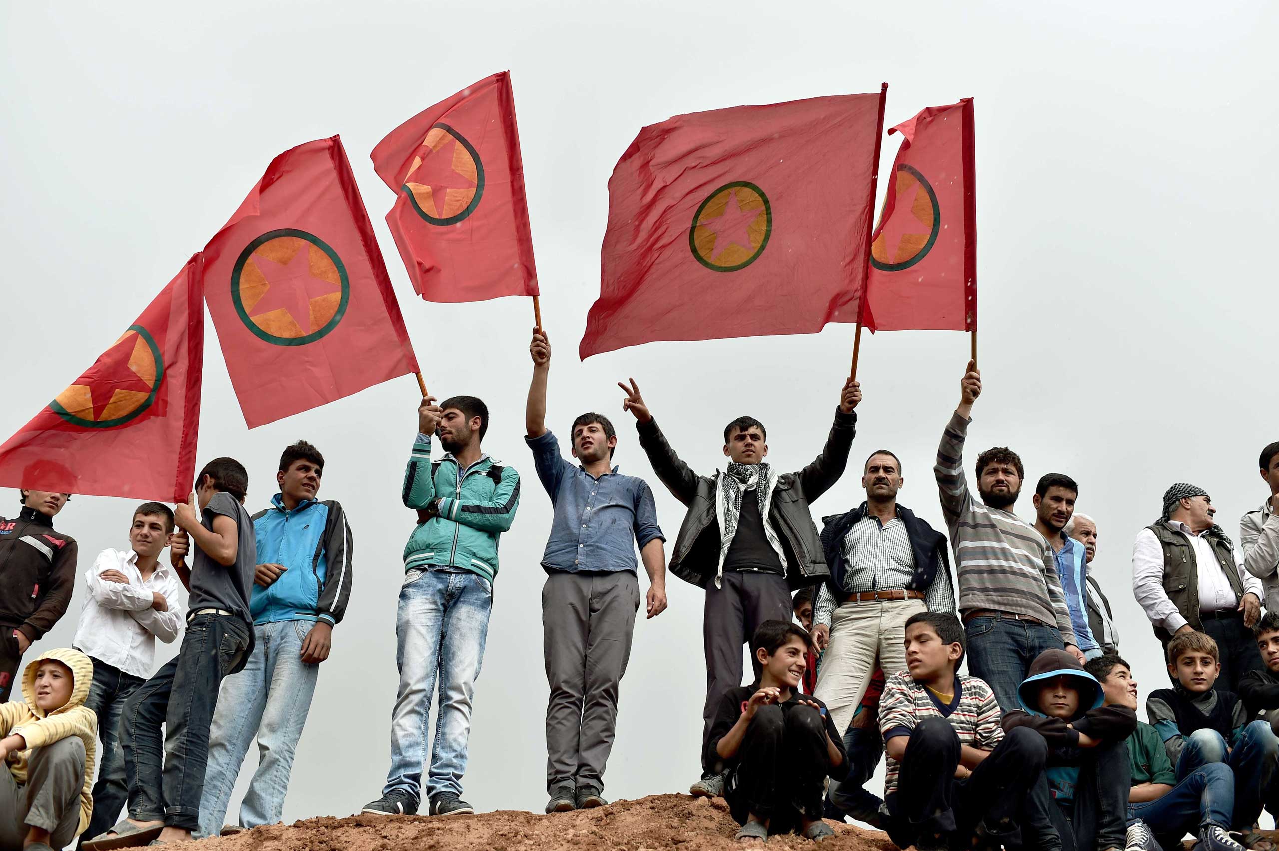 Kurdish people wave Kurdistan Workers' Party (PKK) flags while attending a funeral ceremony for YPG (People's Protection Units) fighters in the town of Suruc, Sanliurfa province, on Oct. 14, 2014.