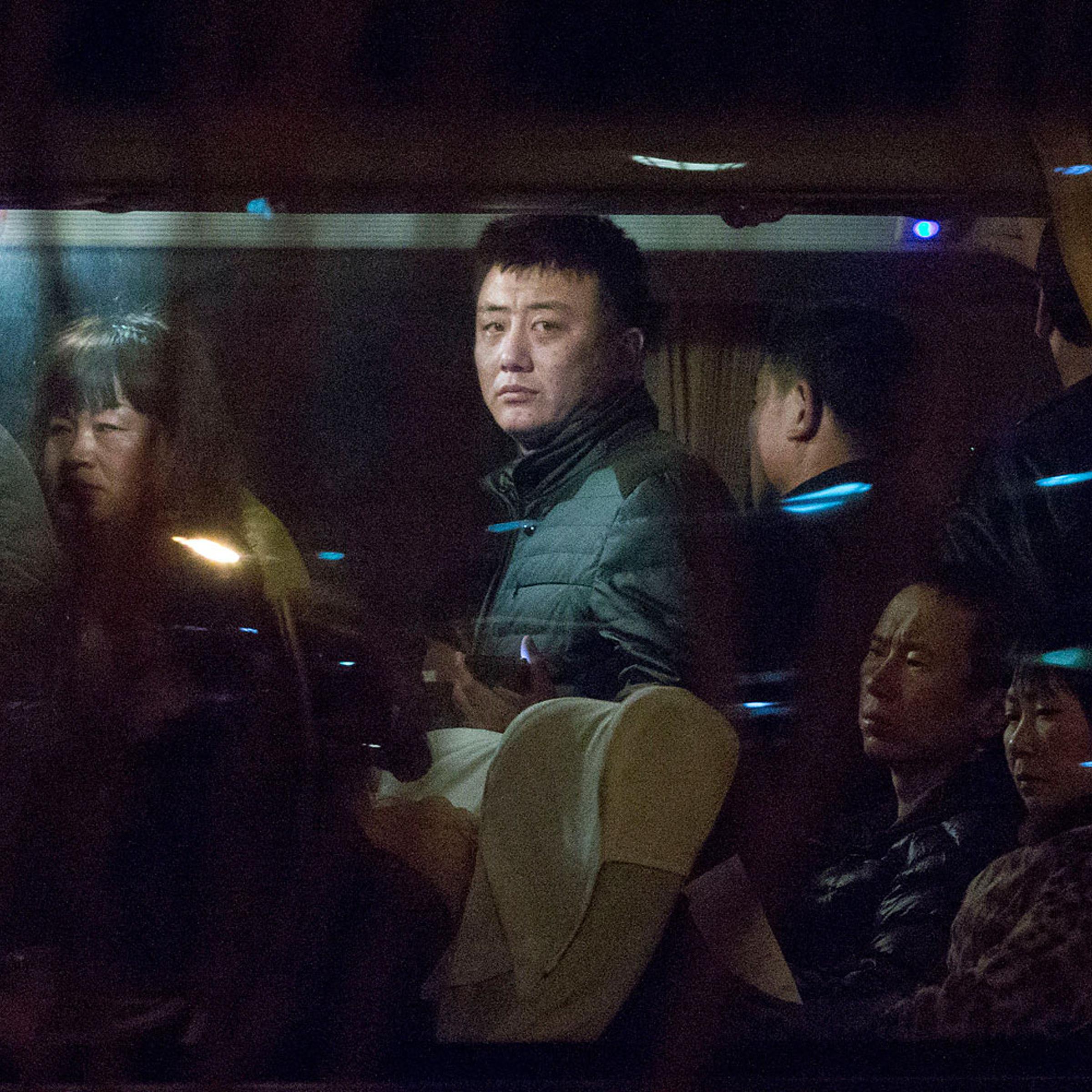 Relatives of Chinese passengers aboard a missing Malaysia Airlines plane wait on a bus on theirway to get paper work to fly to Malaysia, in Beijing, March 9, 2014.