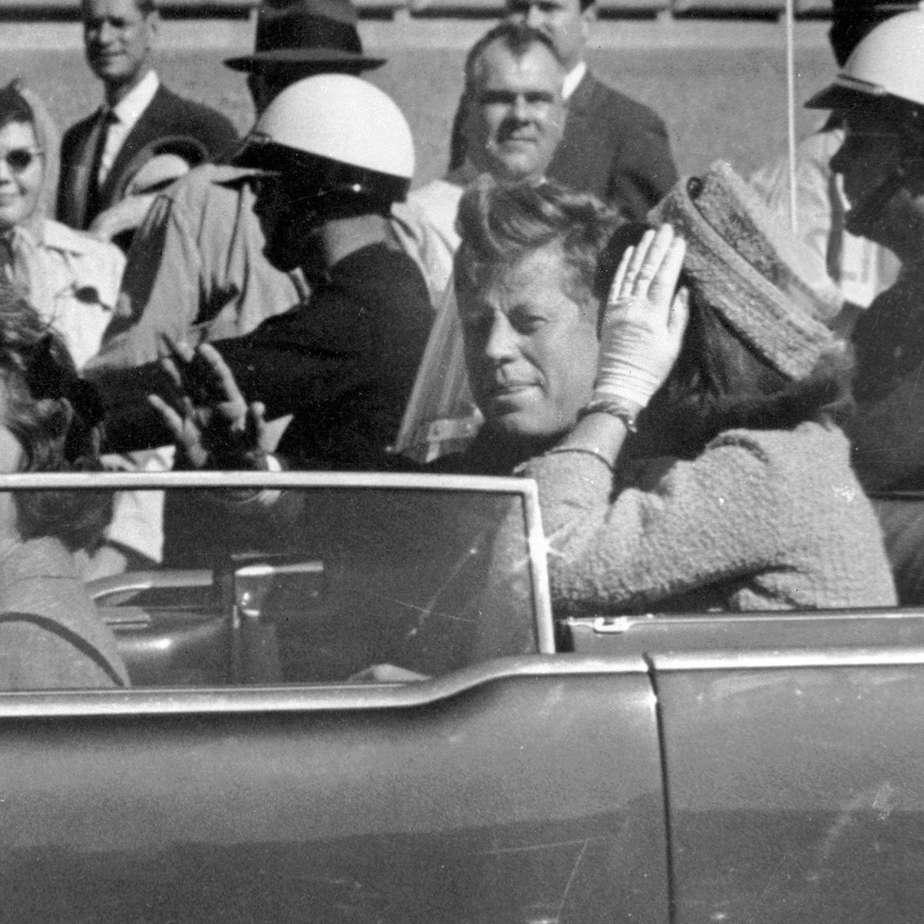 President John F. Kennedy waves from his car in a motorcade in Dallas on Nov. 22, 1963.