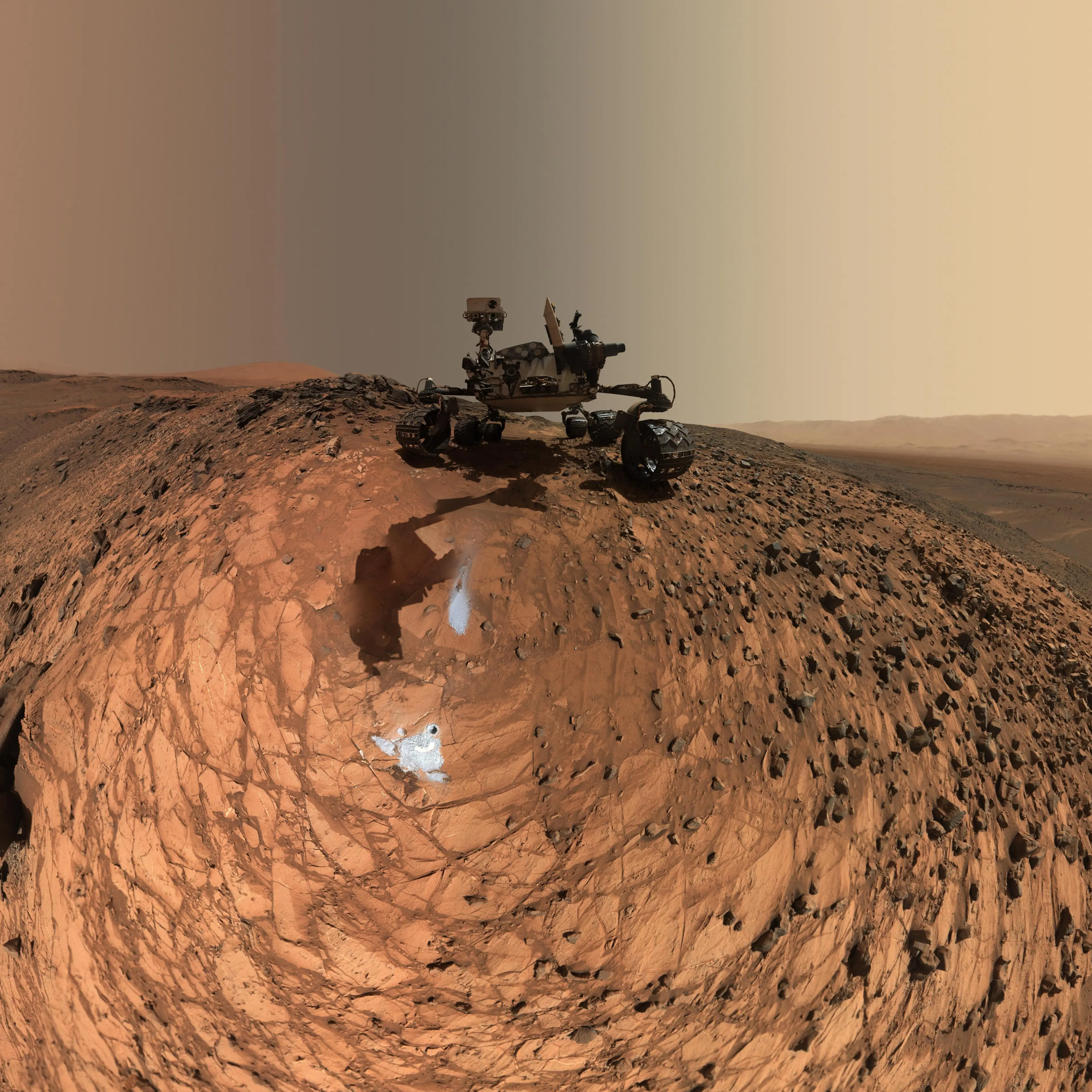 This low-angle self-portrait of NASA's Curiosity Mars rover shows the vehicle above the 'Buckskin' rock target, where the mission collected its seventh drilled sample. The site is in the 'Marias Pass' area of lower Mount Sharp.