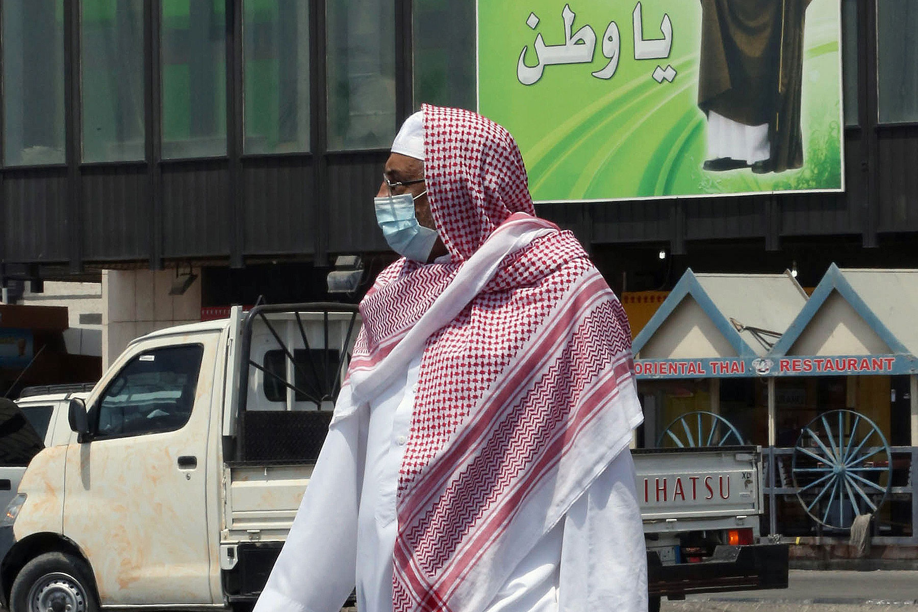 A Saudi man wears a mouth and nose mask as he walks in a street of the Red Sea coastal city of Jeddah on April 27, 2014