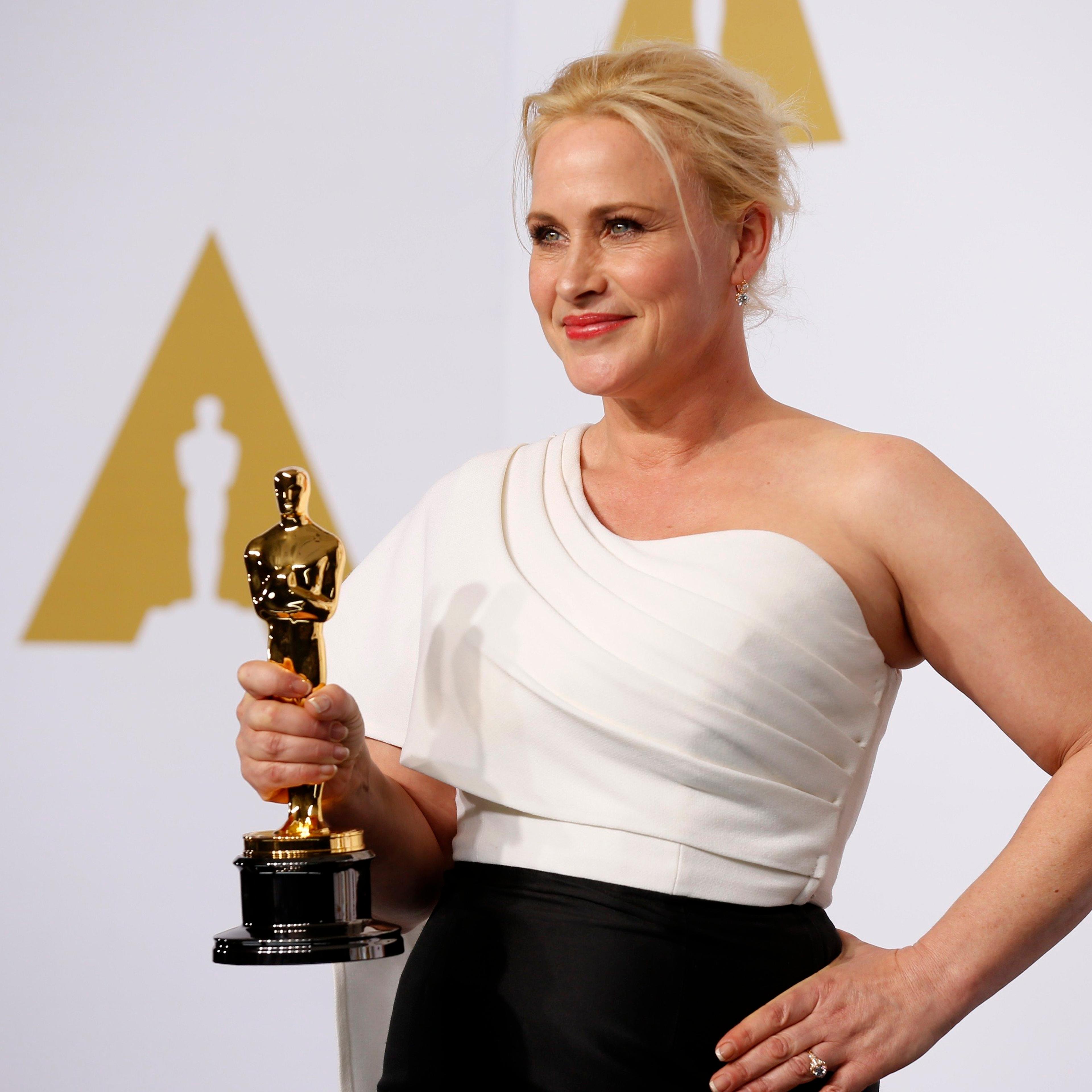 Patricia Arquette, best supporting actress winner for her role in "Boyhood," poses with her award during the 87th Academy Awards in Hollywood