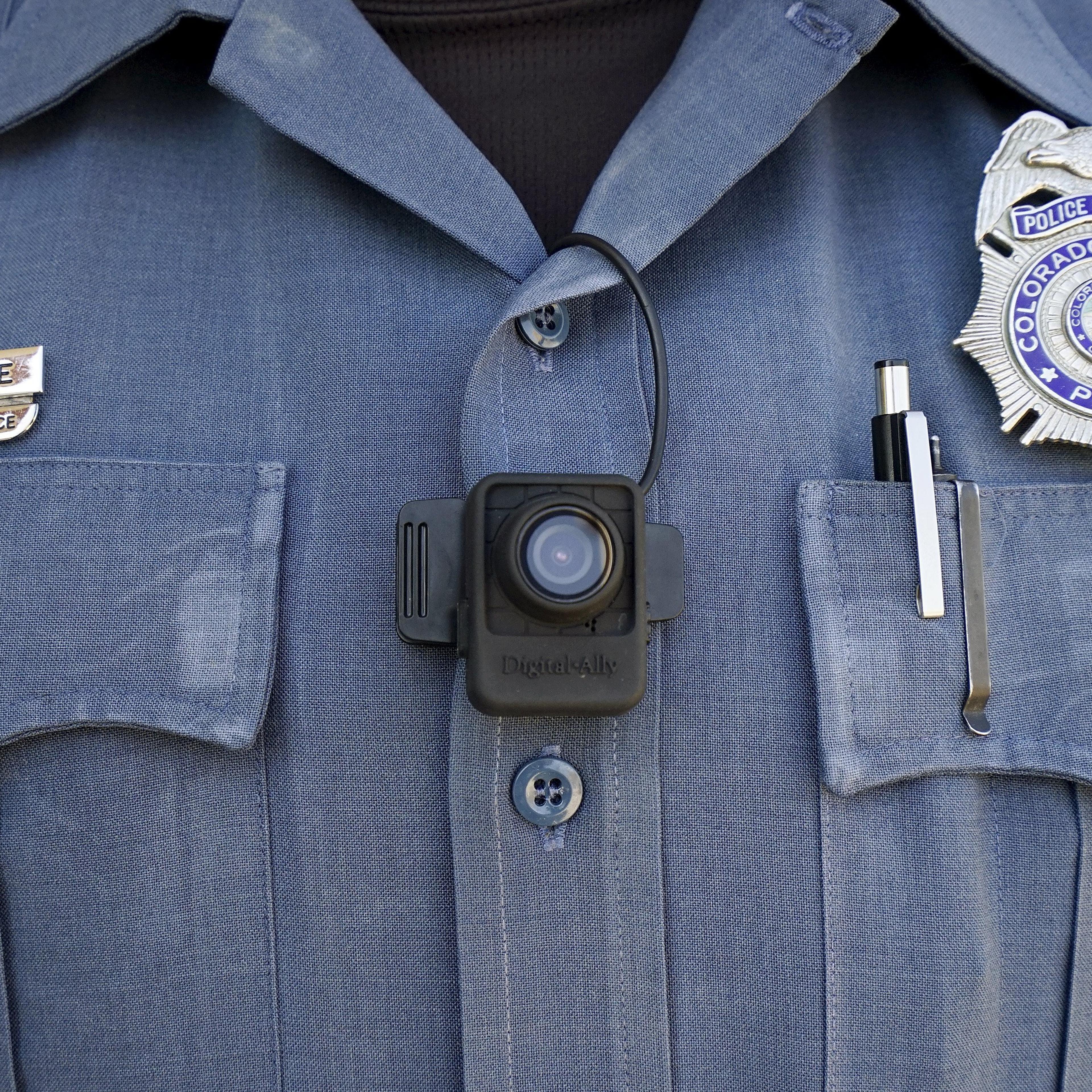 Brian Gurule, a Colorado Springs motor officer poses with a Digital Ally First Vu HD body worn camera worn on his chest in Colorado Springs on April 21, 2015.
