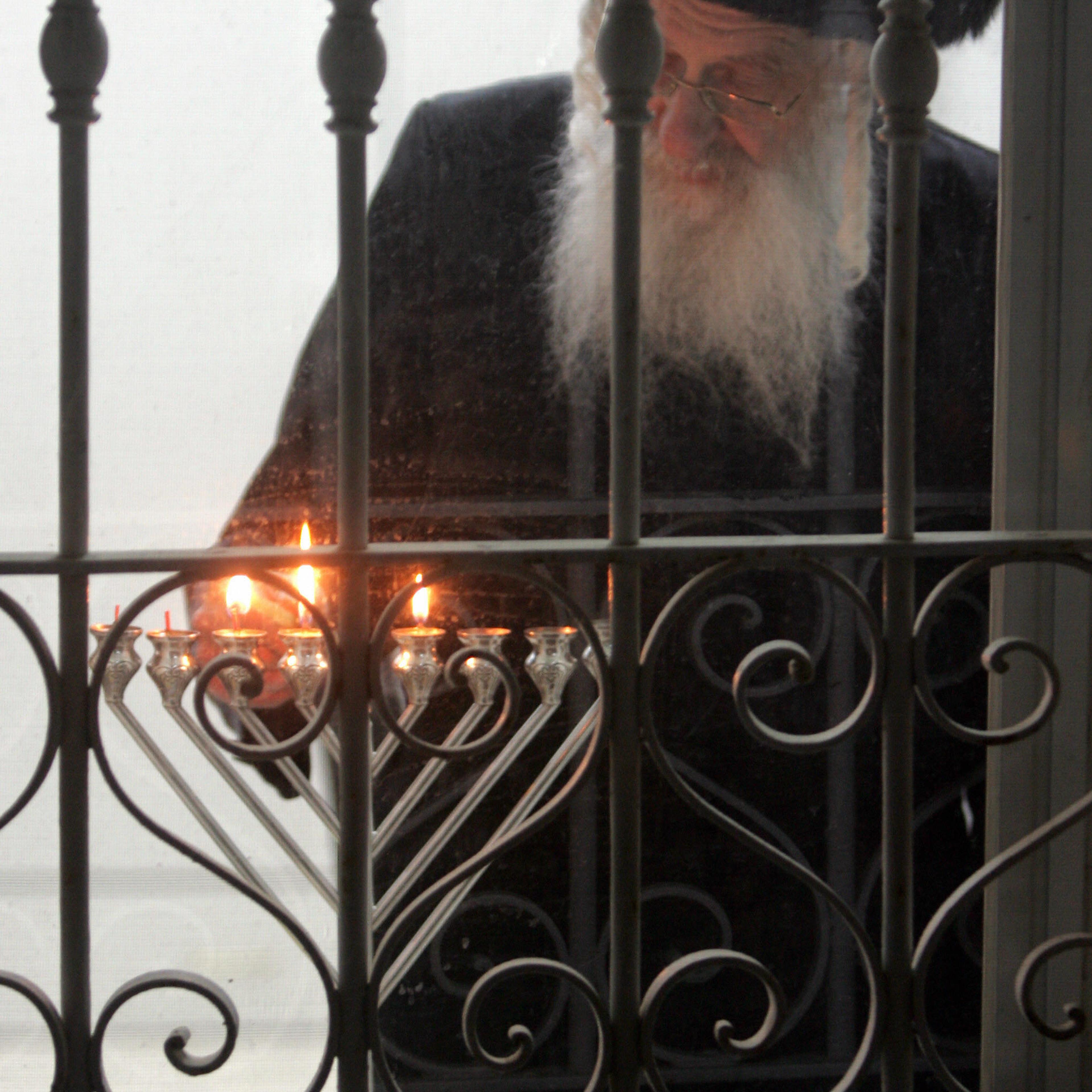 An Ultra-Orthodox Jewish man lights the