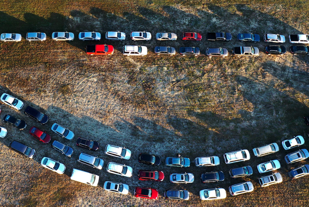 In this aerial view from a drone, people line up in their cars to receive food assistance at the Share Your Christmas food distribution event sponsored by the Second Harvest Food Bank of Central Florida, Faith Neighborhood Center and WESH 2 at Hope Inter