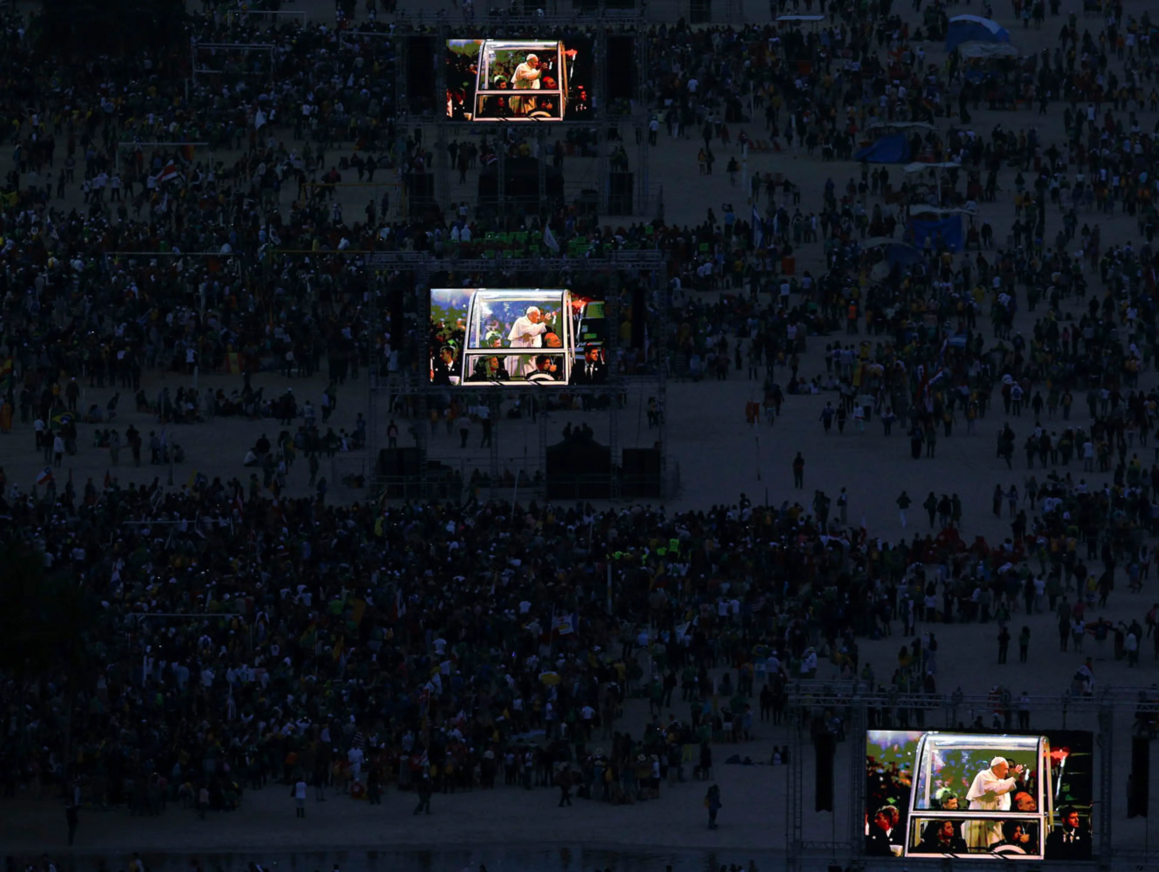 Pope Francis is projected on screens at Copacabana beach in Rio de Janeiro