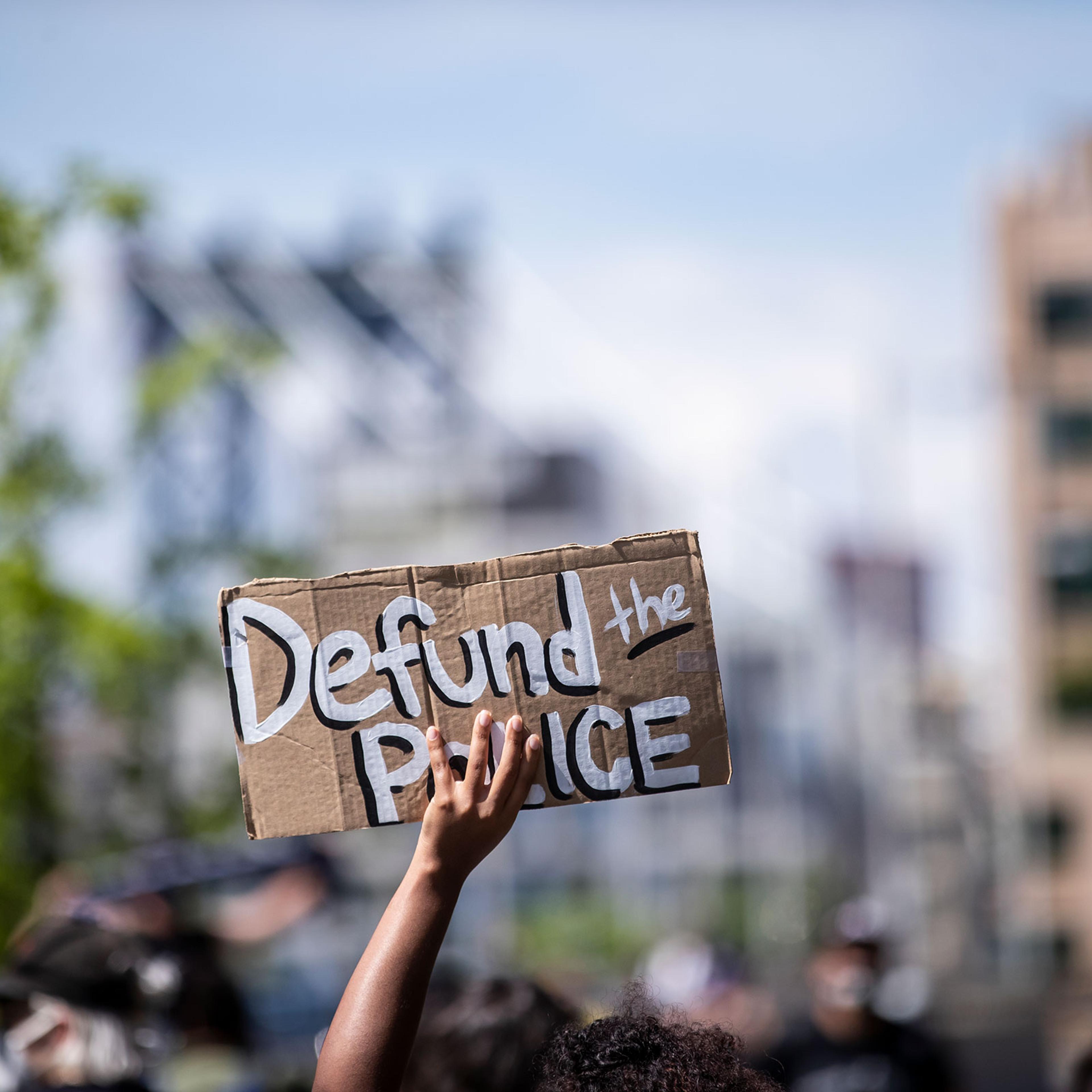 A protester holds up a homemade sign that says, "Defund the Police" during a peaceful protest in New York City June 19, 2020.