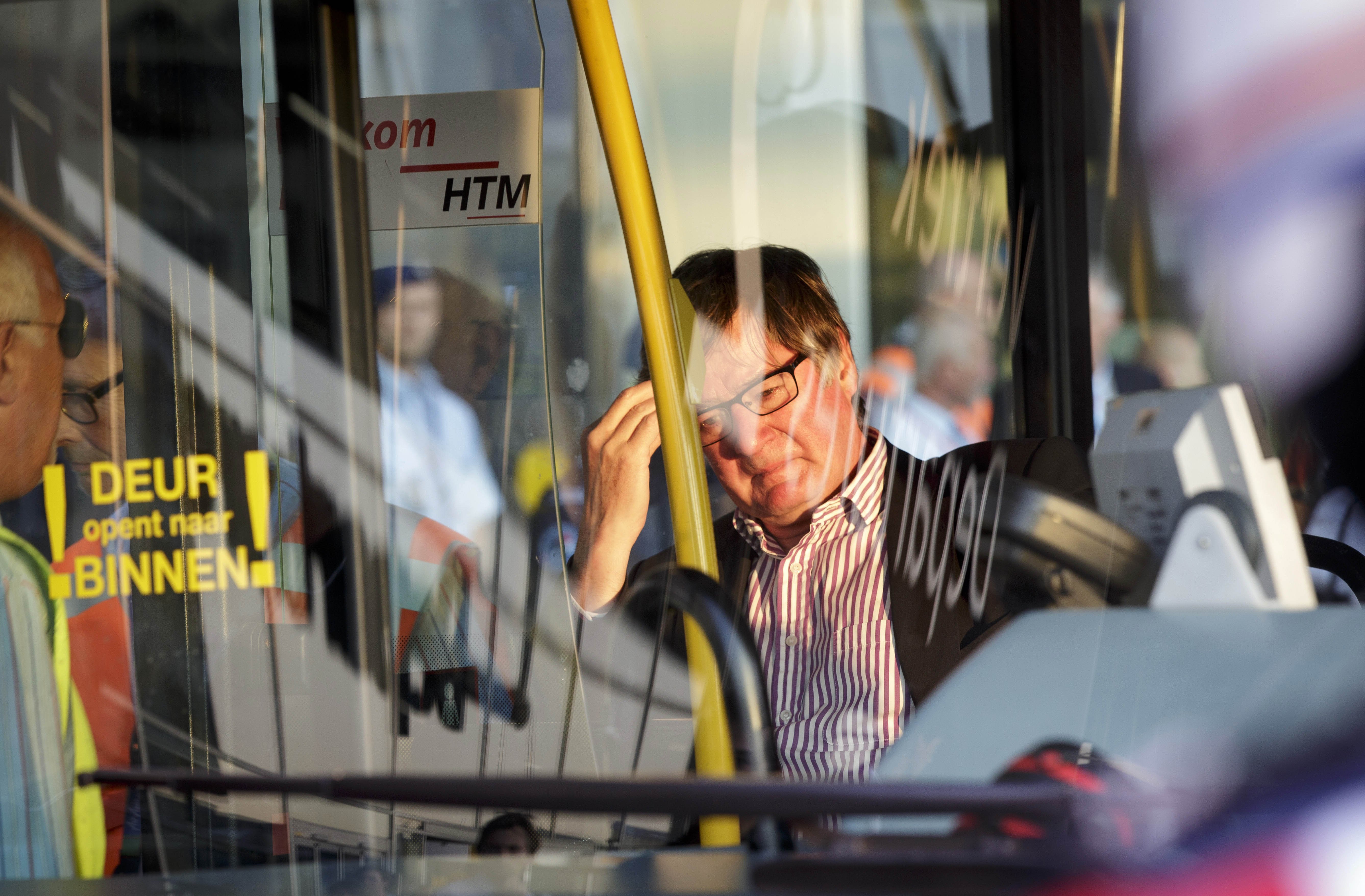 A relative of passenger on flight MH17 waits in a bus to be transported to an unknown location to receive more information, at Schiphol airport in Amsterdam on July 17, 2014.