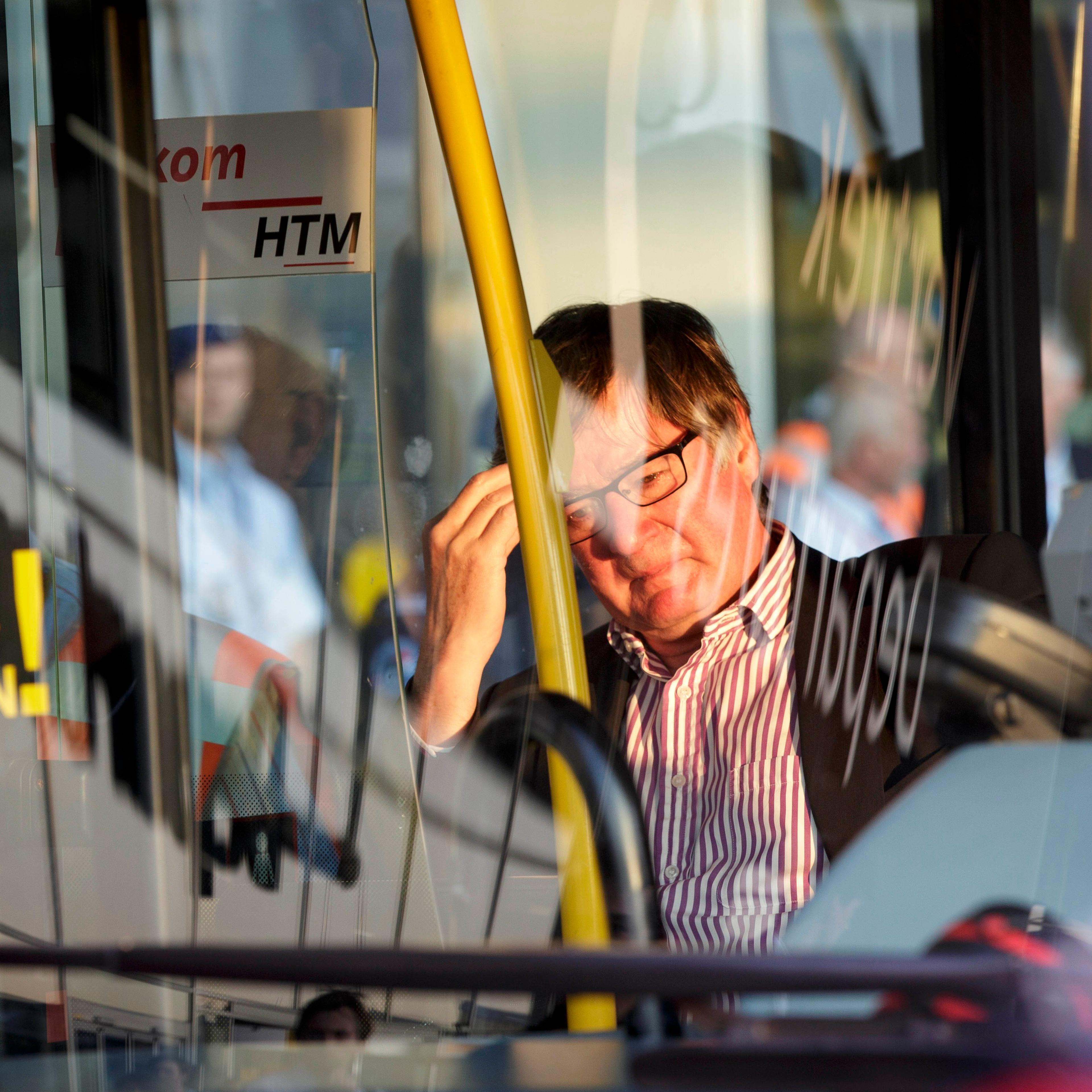 A relative of passenger on flight MH17 waits in a bus to be transported to an unknown location to receive more information, at Schiphol airport in Amsterdam on July 17, 2014.