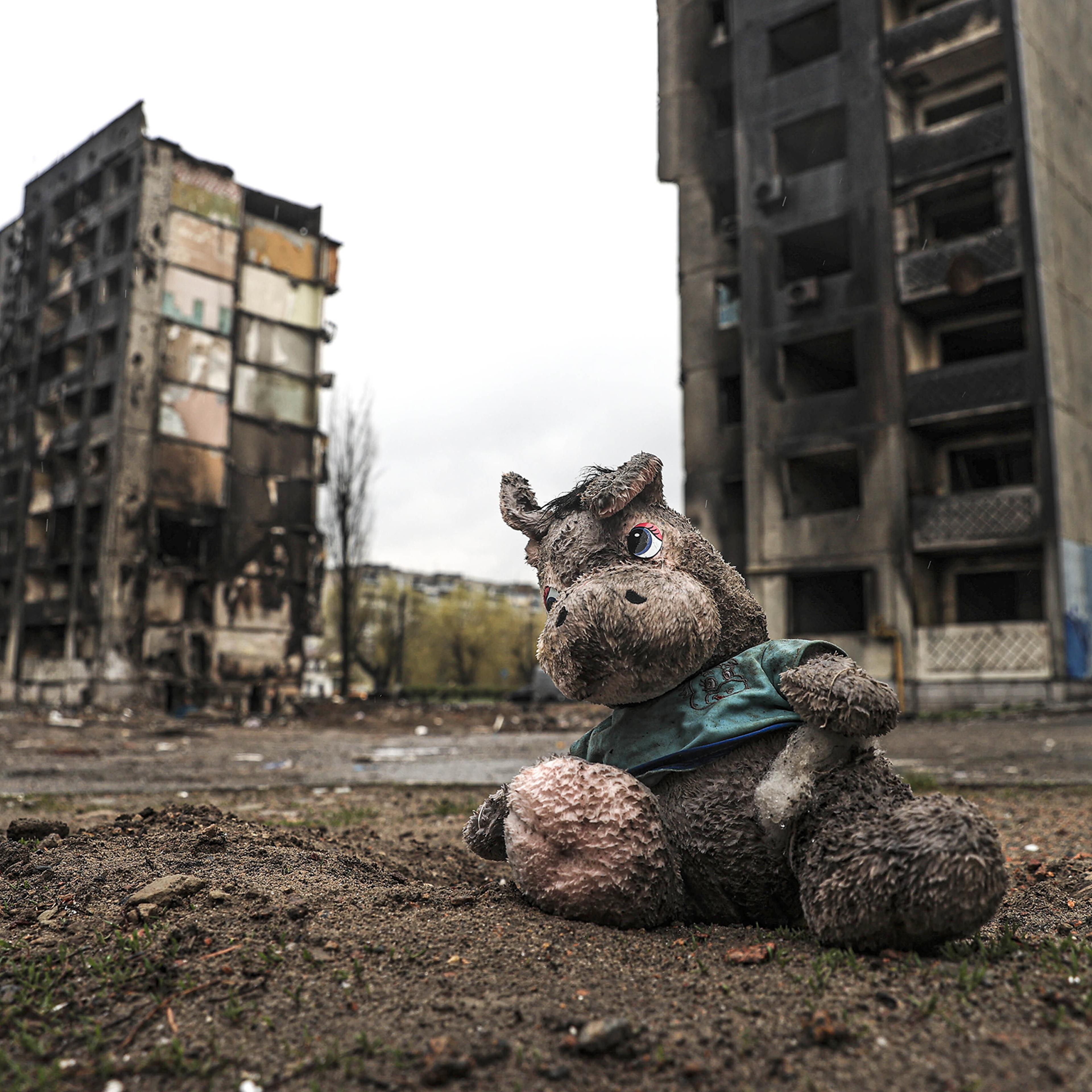 A muddy toy separated from a Ukrainian child is seen among the ruins