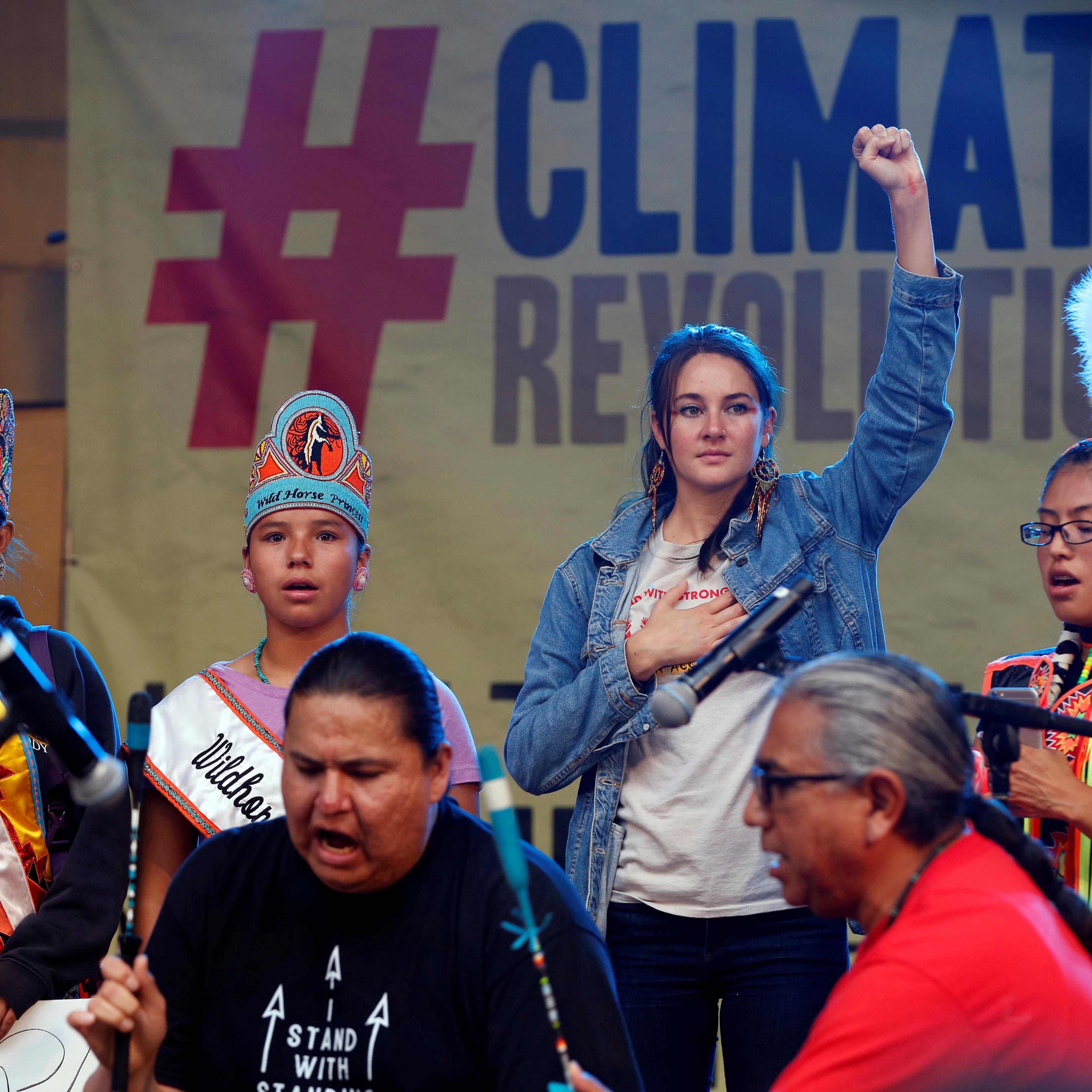 Actor Shailene Woodley stands with Native Americans on stage during a climate change rally in solidarity with protests of the pipeline in North Dakota at MacArthur Park in Los Angeles, California