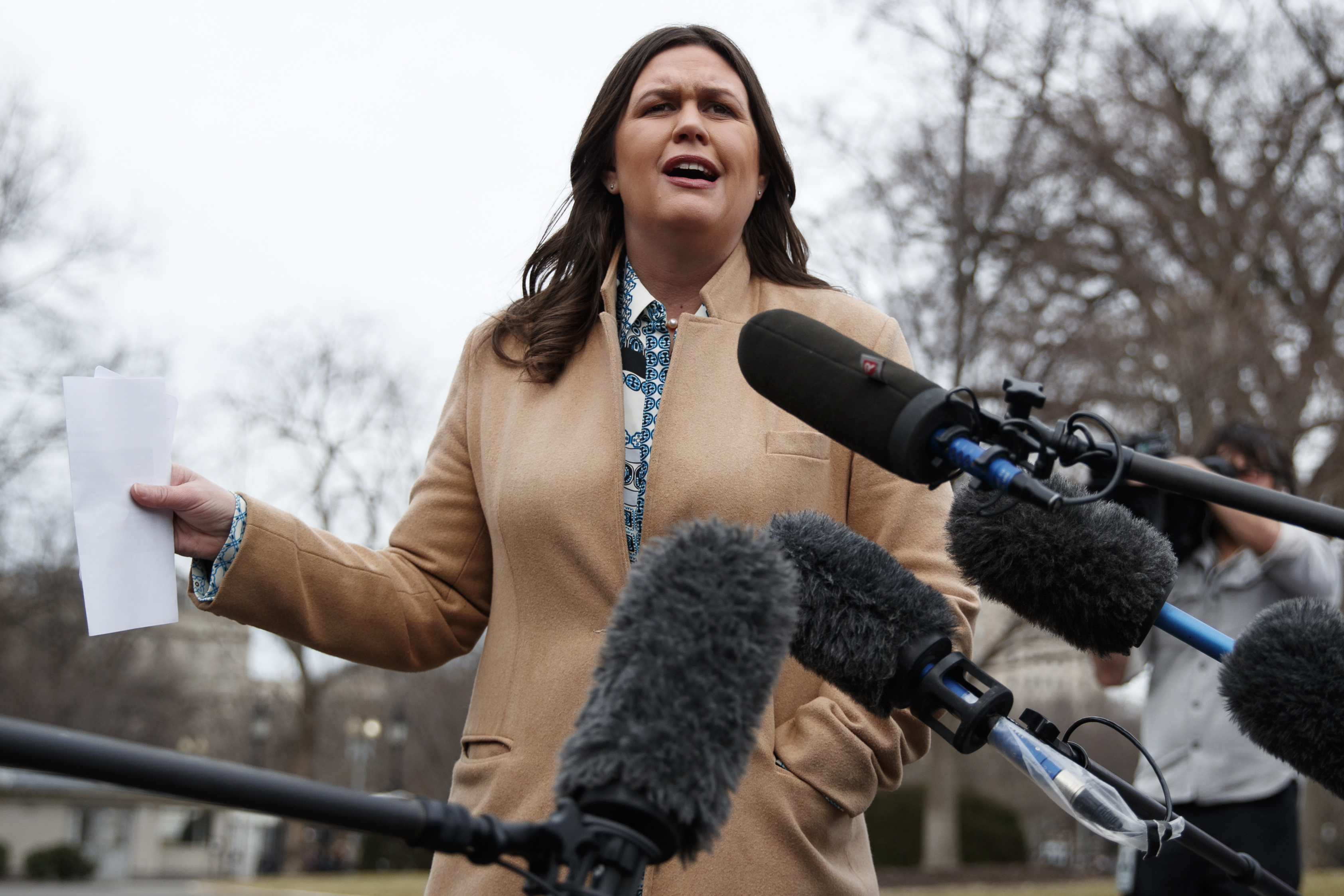 White House press secretary Sarah Sanders talks with reporters outside the White House