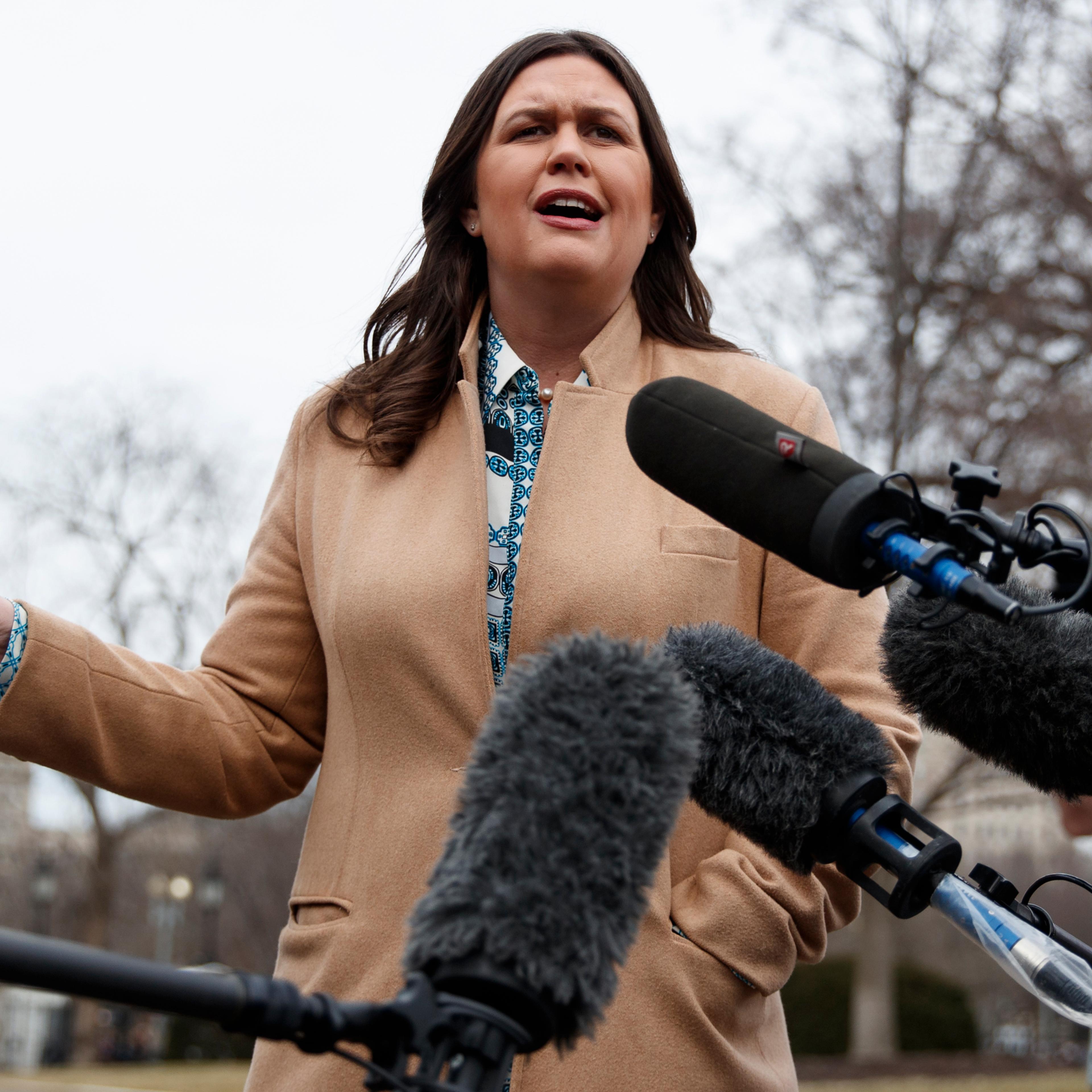 White House press secretary Sarah Sanders talks with reporters outside the White House