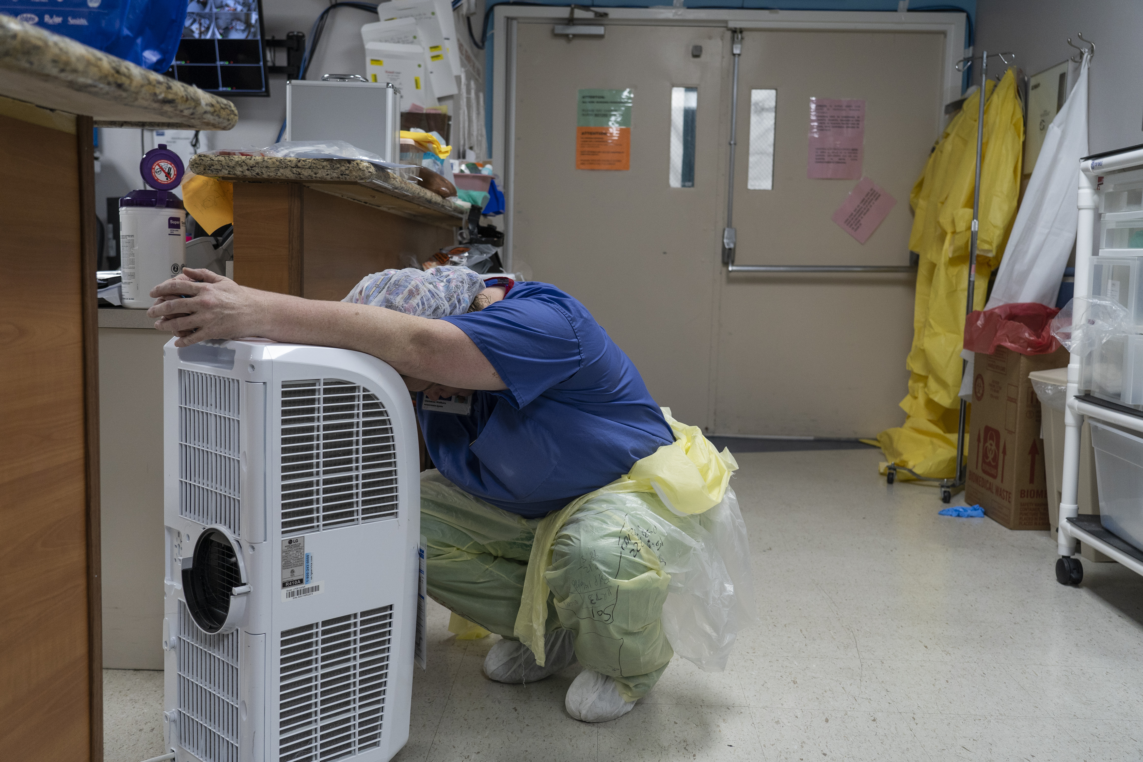 A medical staff member rests in front of a fan in the Covid-19 intensive care unit at the United Memorial Medical Center on June 30, 2020 in Houston, Texas.