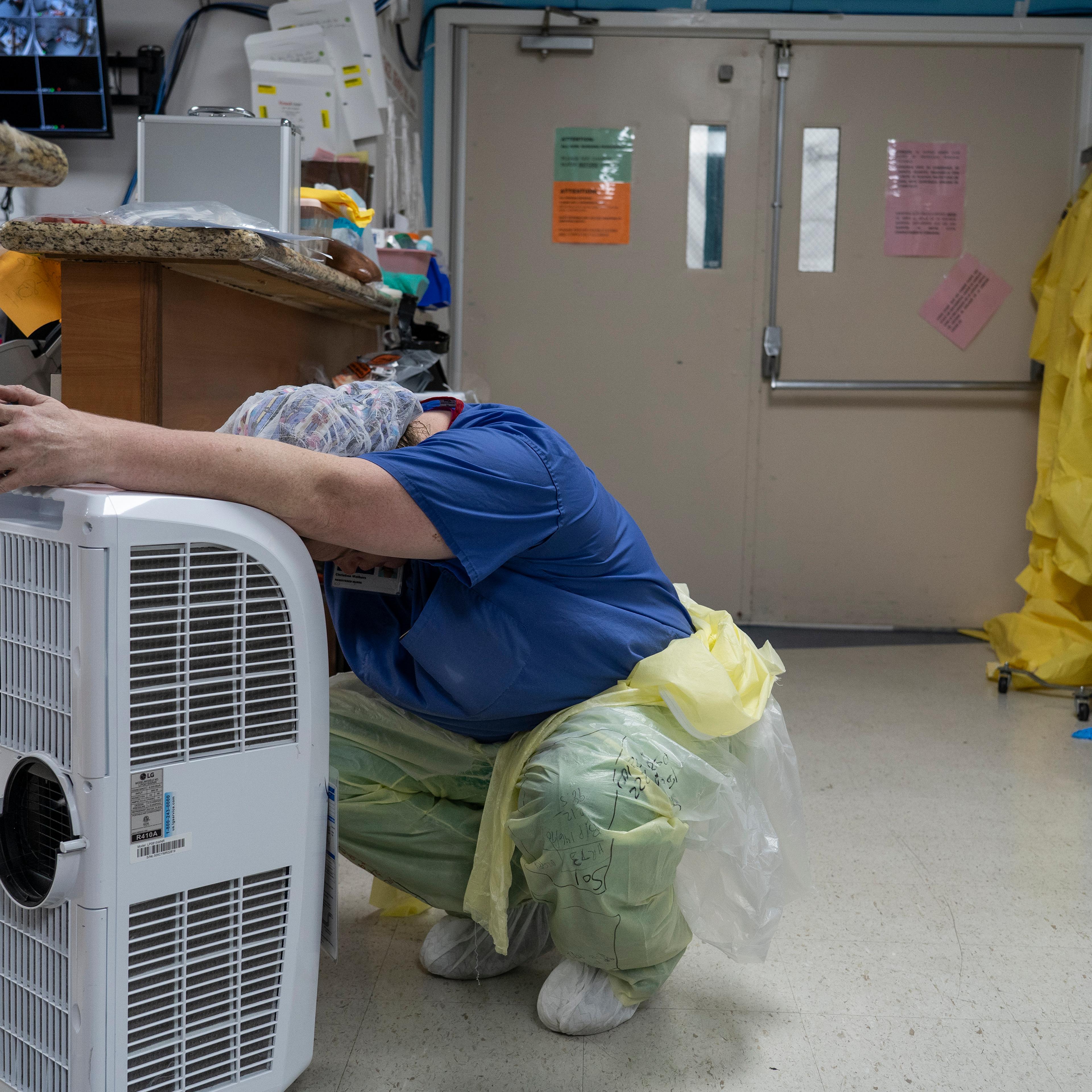A medical staff member rests in front of a fan in the Covid-19 intensive care unit at the United Memorial Medical Center on June 30, 2020 in Houston, Texas.