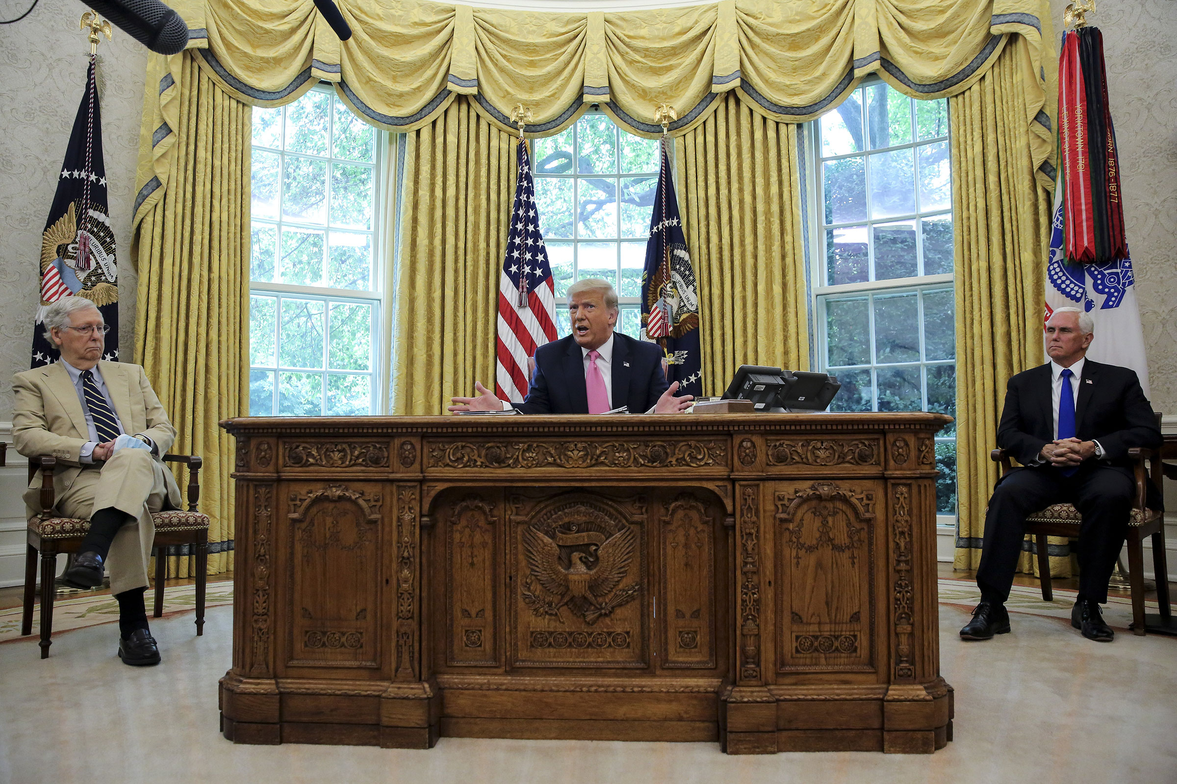 President Donald Trump speaks as Senate Majority Leader Mitch McConnell Vice President Mike Pence listen during a meeting in the Oval Office of the White House on July 20, 2020. 