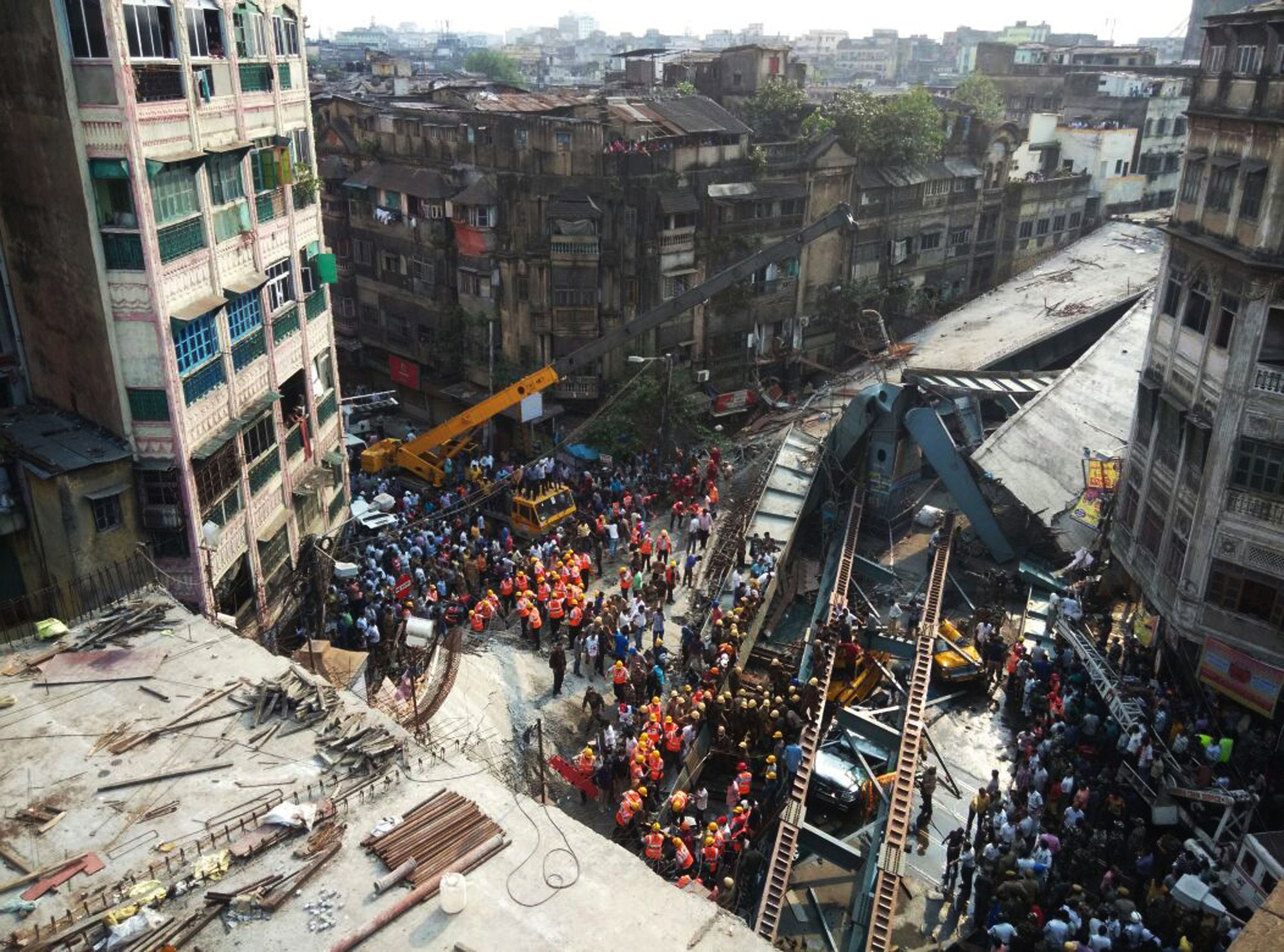 Locals and rescue workers clear the rubble of a partially collapsed overpass in Kolkata, India, March 31, 2016.