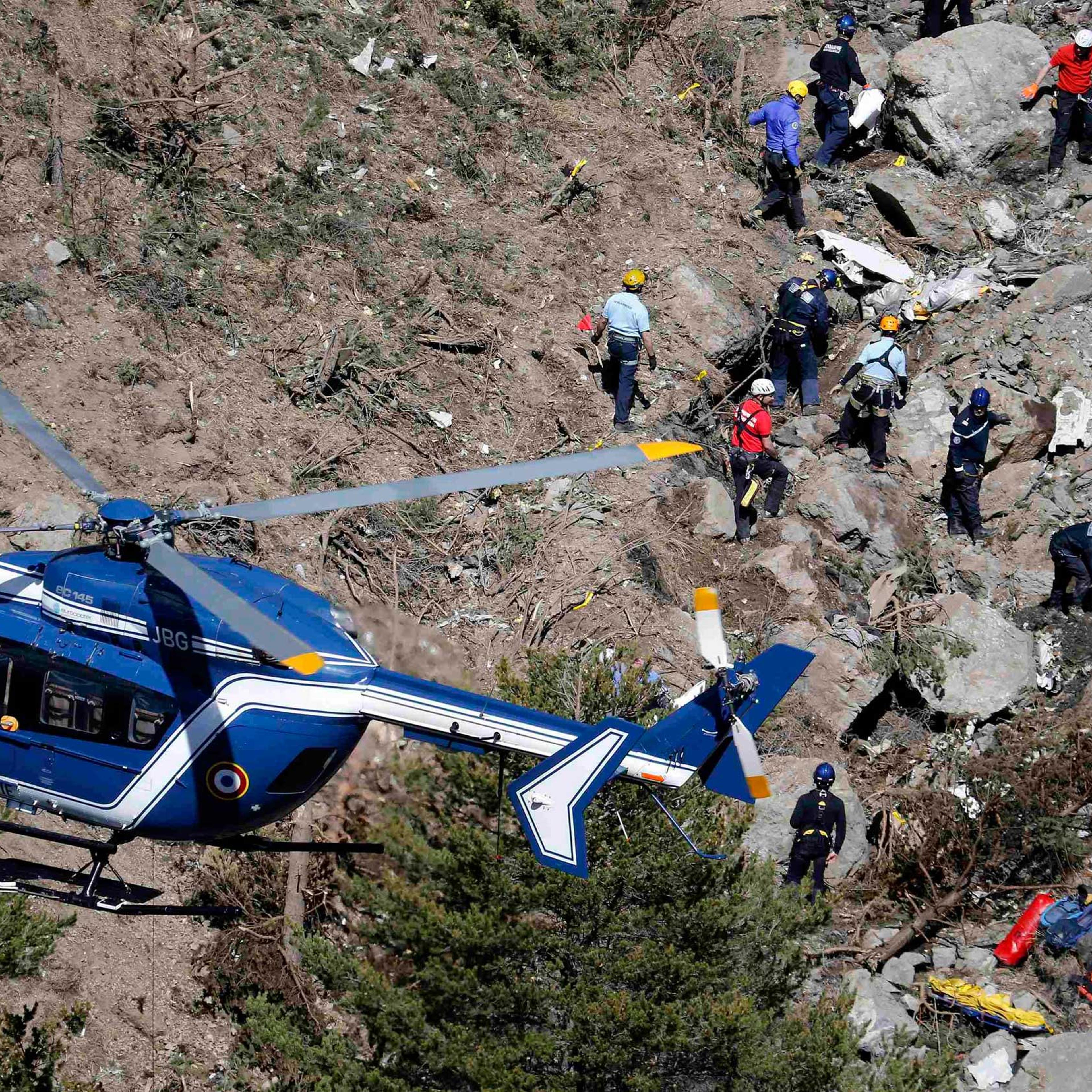 French gendarmes and investigators work amongst the debris of the Airbus A320 at the site of the crash, near Seyne-les-Alpes, in the French Alps, on March 26, 2015.