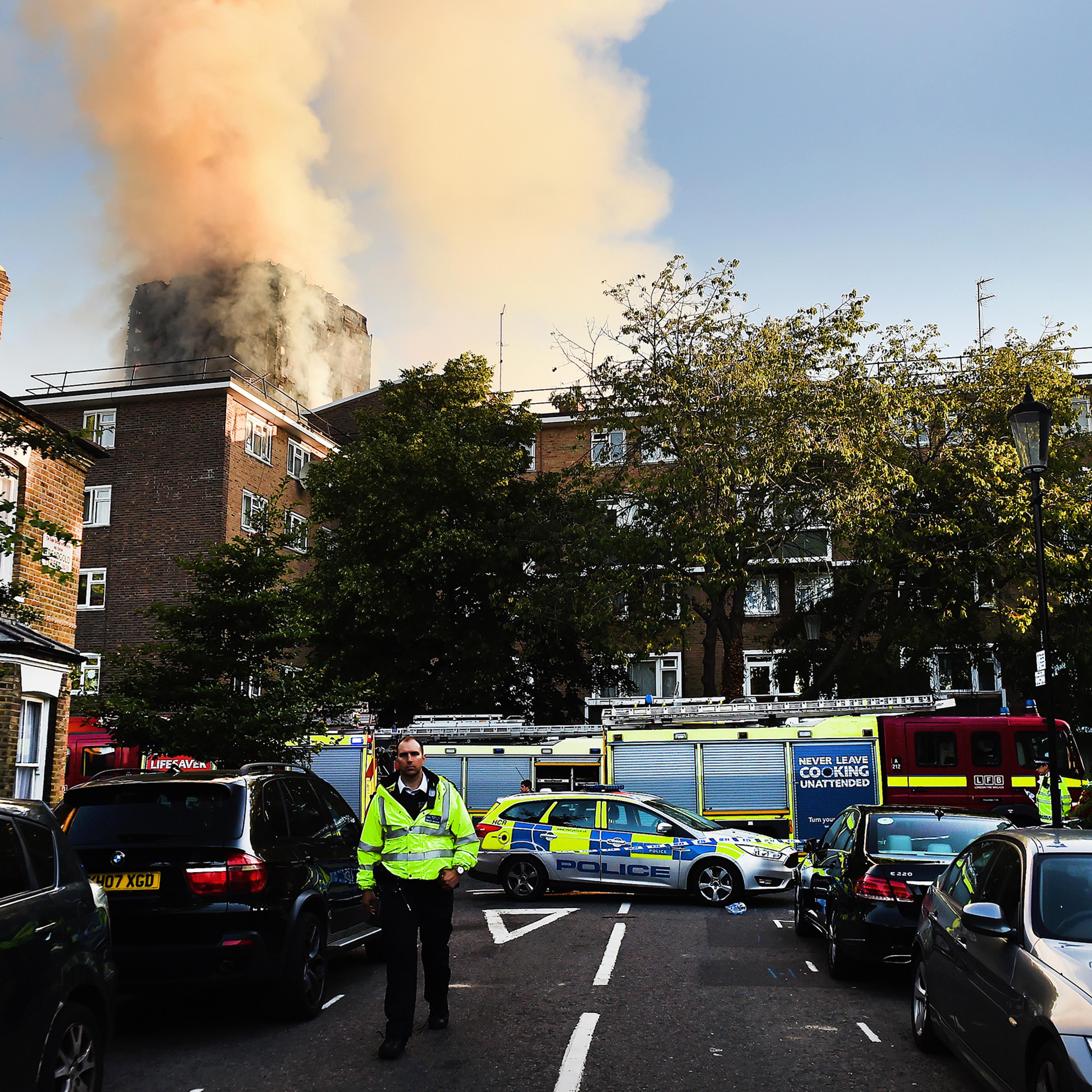 Police and rescue services operate near the fire at the Grenfell Tower apartment block in North Kensington, London, on June 14, 2017.