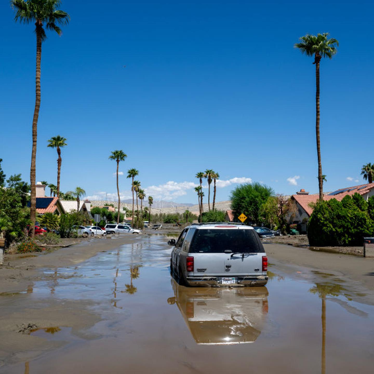 An SUV is one of many stuck vehicles still stuck in the mud and flood waters after tropical storm Hilary sent damaging flood water to Horizon Road on Aug. 22, 2023 in Cathedral City, California.