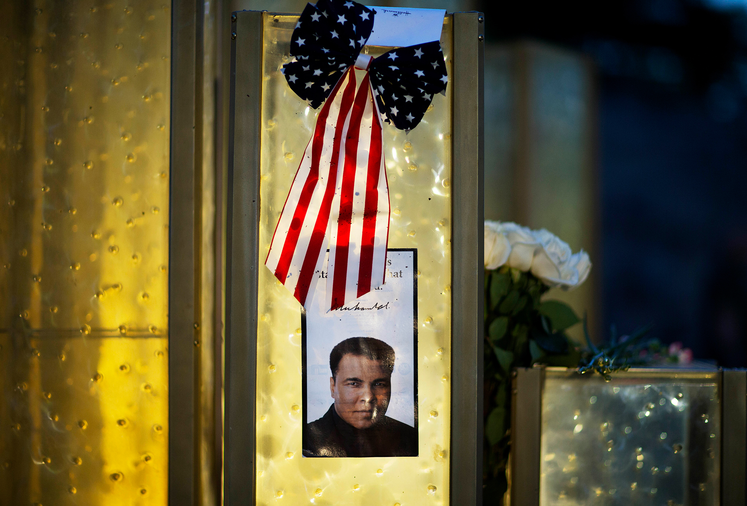 An image of Muhammad Ali is posted at a makeshift memorial to him at the Muhammad Ali Center, Saturday, June 4, 2016, in Louisville, Ky. Ali died Friday at age 74. (AP Photo/David Goldman)