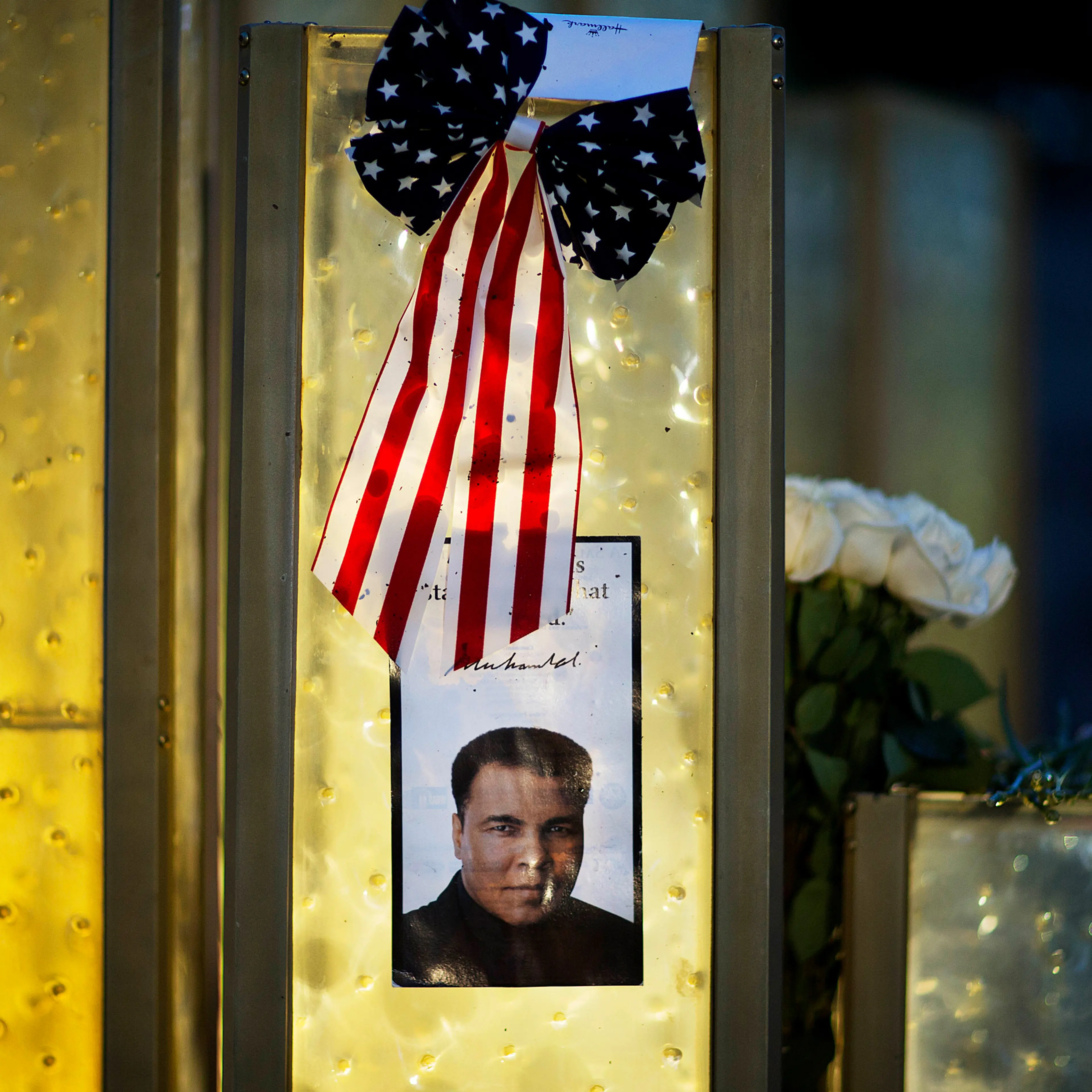 An image of Muhammad Ali is posted at a makeshift memorial to him at the Muhammad Ali Center, Saturday, June 4, 2016, in Louisville, Ky. Ali died Friday at age 74. (AP Photo/David Goldman)
