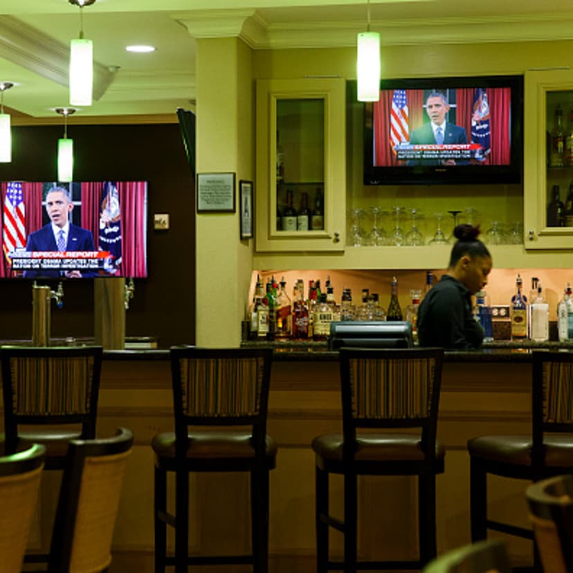 A bartender at a hotel near the Inland Regional Center watches President Obama speak on TV during the aftermath of a mass shooting that killed 14 people on Sunday, December 6, 2015 in San Bernardino, California.