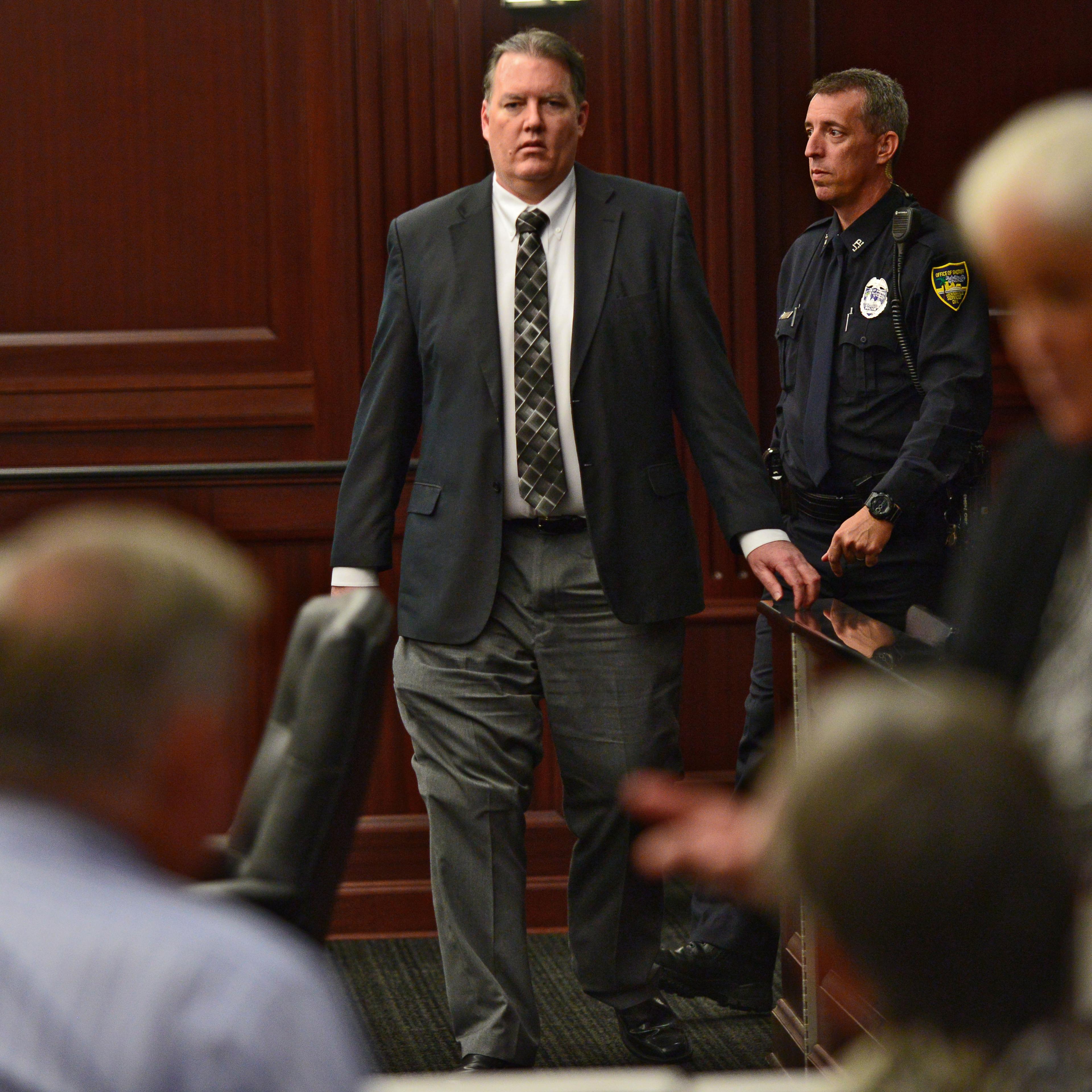 Defendant Michael Dunn walks back into the courtroom after a short afternoon break during his trial in the Duval County Courthouse in Jacksonville, Fla. on Sept. 27, 2014.