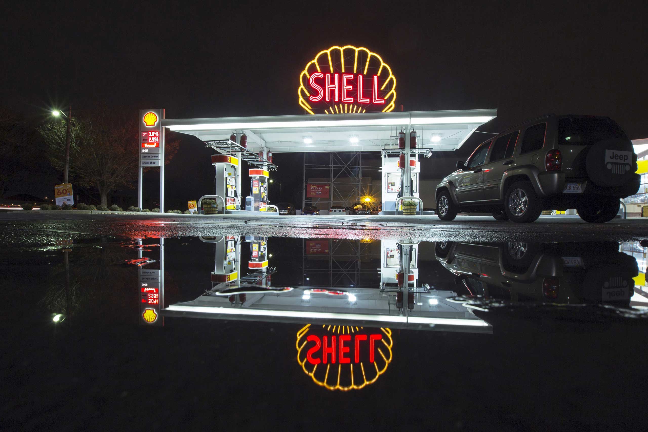A vintage Shell sign is seen illuminated at a Shell gas station in Cambridge, Mass., in 2014.
