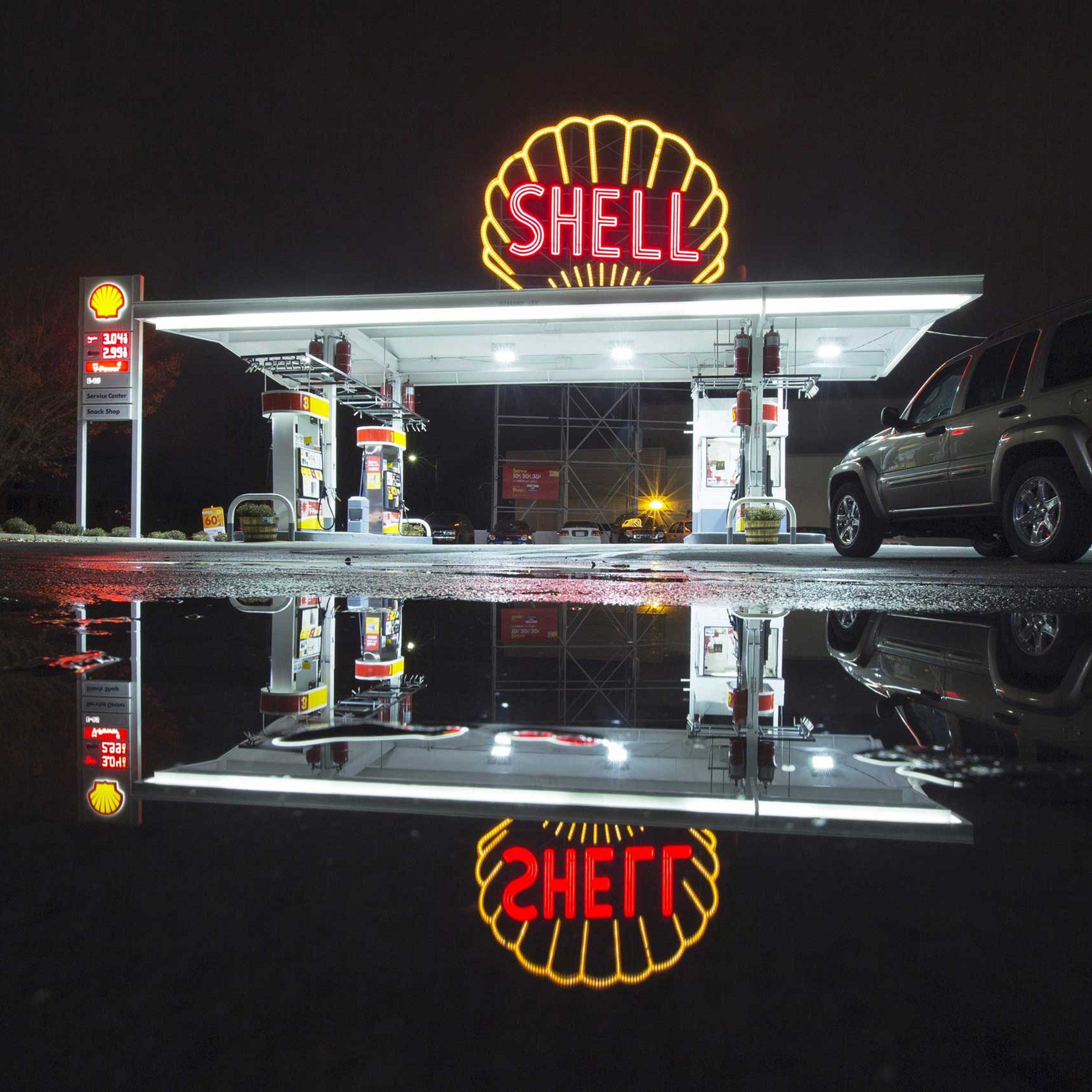 A vintage Shell sign is seen illuminated at a Shell gas station in Cambridge, Mass., in 2014.