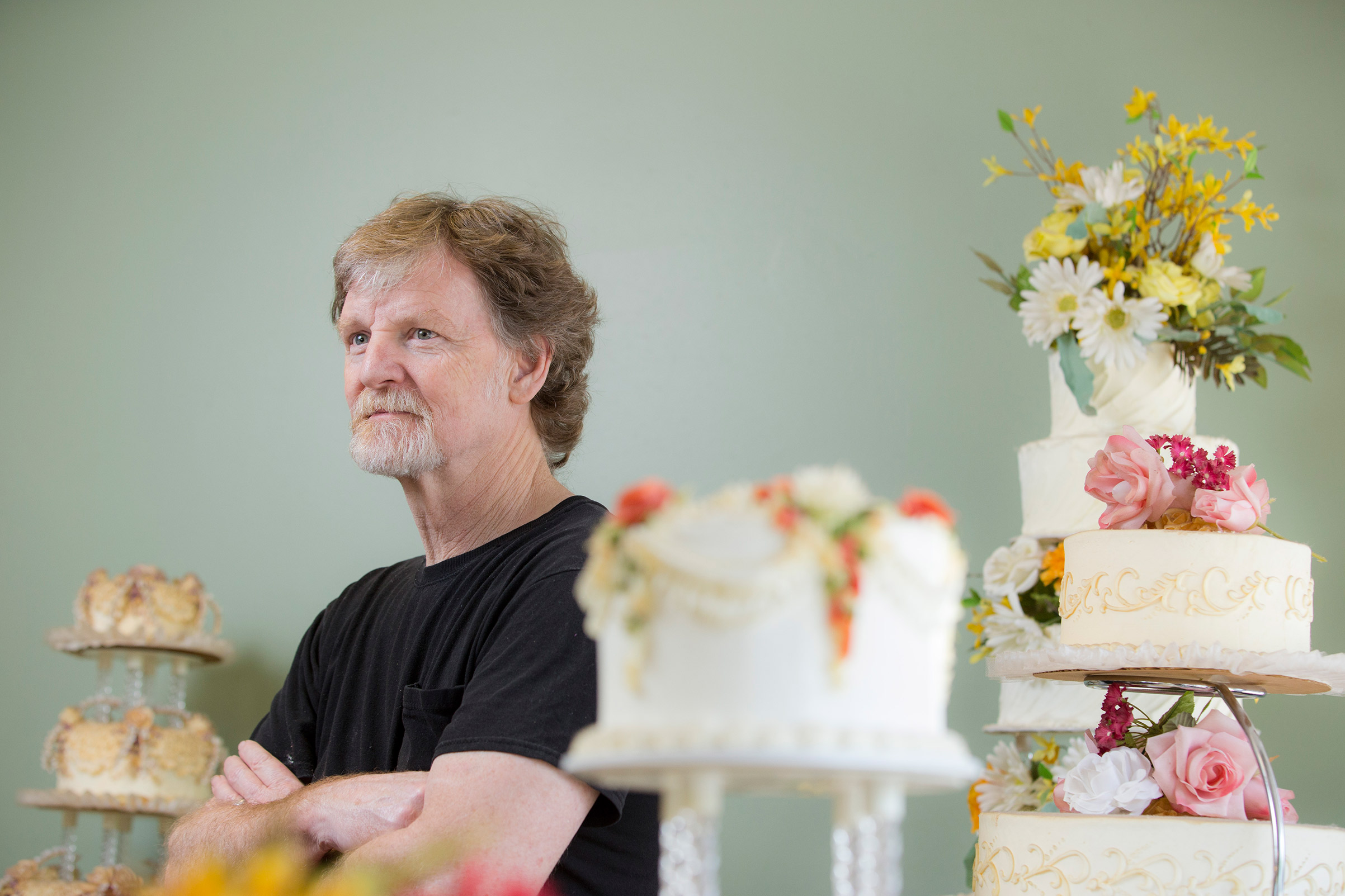 Jack Phillips stands for a portrait near a display of wedding cakes in his Masterpiece Cakeshop in Lakewood, CO, on September 1, 2016.