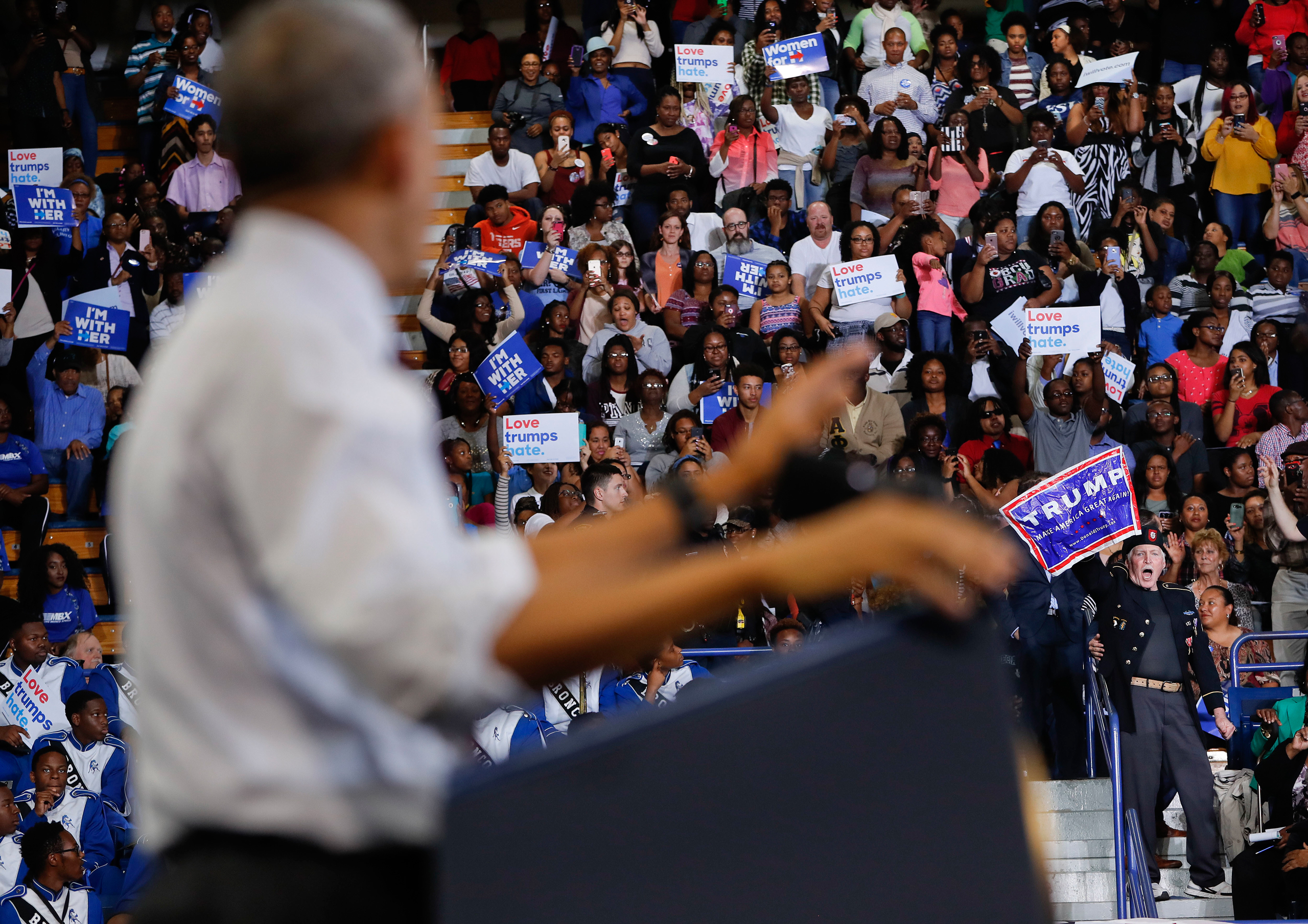 A supporter for Republican presidential candidate Donald Trump, right, interrupts President Barack Obama's speech at Fayetteville State University, Friday, Nov. 4, 2016 in Fayetteville, N.C., during a campaign rally for Democratic presidential candidate 