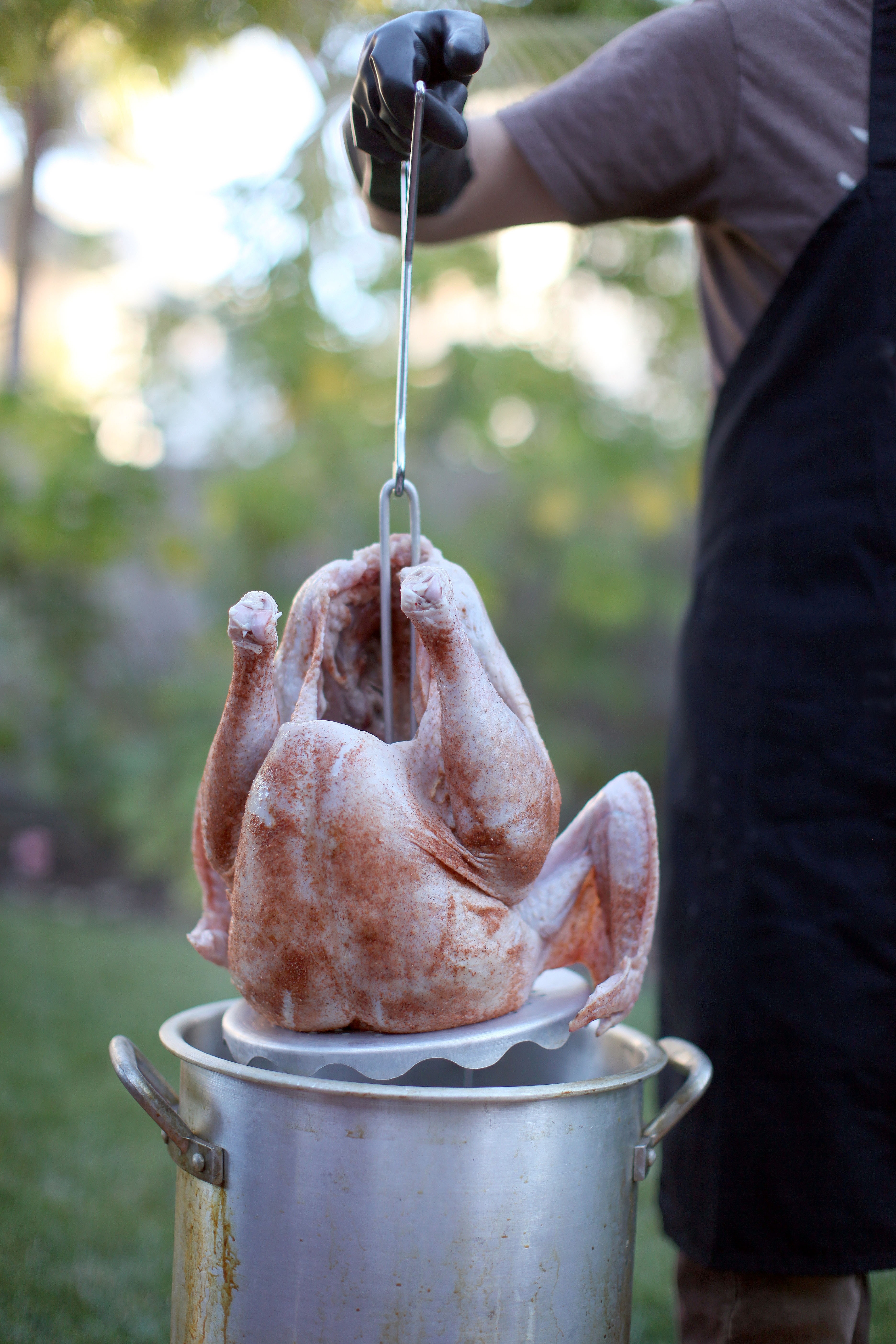 Man deep frying turkey in pot