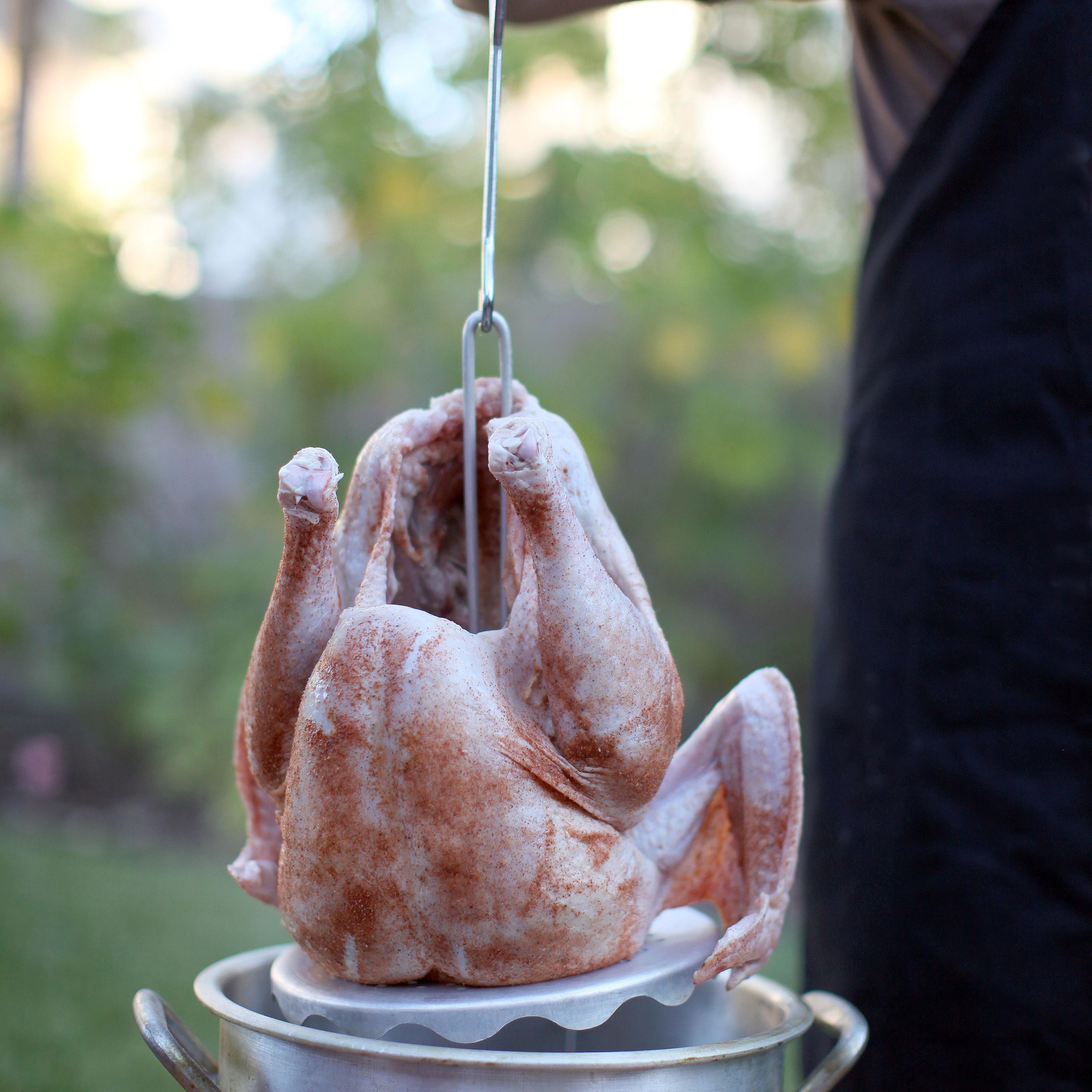 Man deep frying turkey in pot
