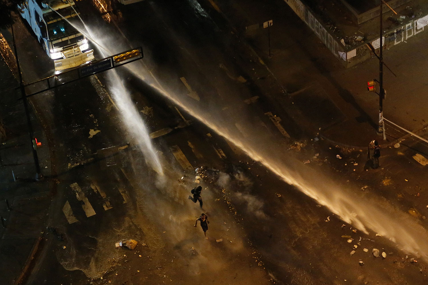 The national guard disperses water cannons on anti-government protesters during a protest at Altamira square in Caracas