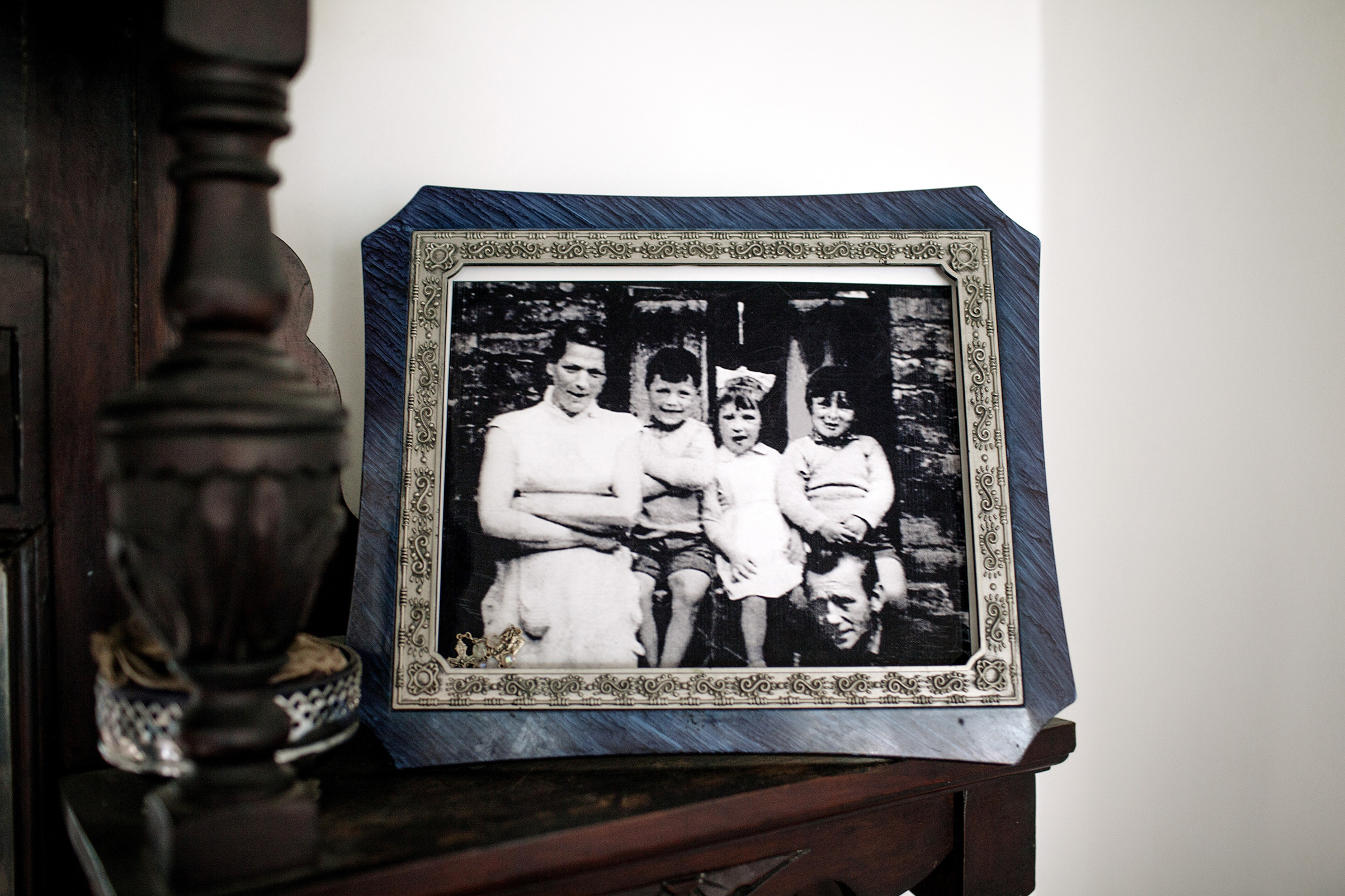 A portrait of the McConville family in the home of Helen McKendry, daughter of Jean McConville (left), a widowed Belfast mother of 10 who was killed in 1972.