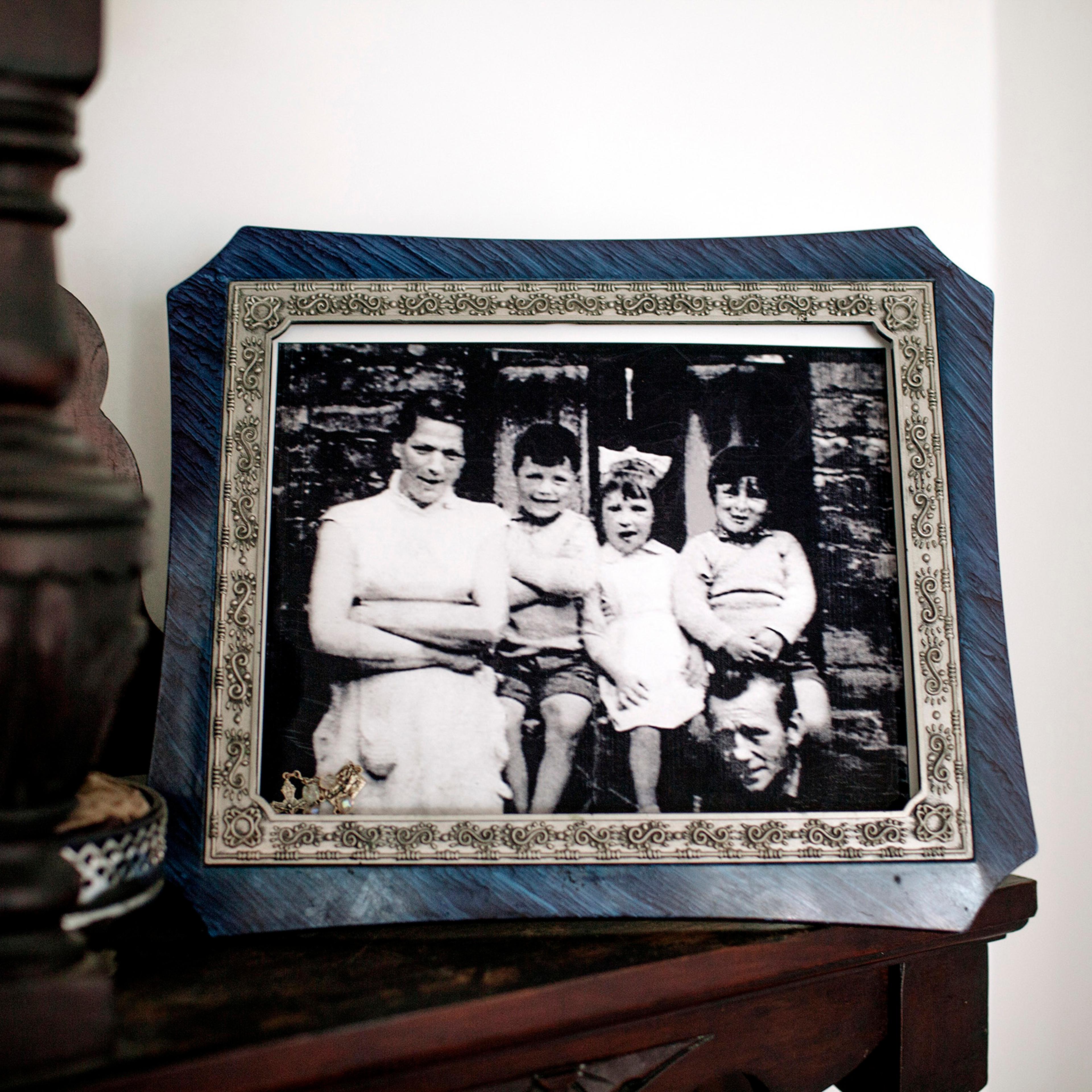 A portrait of the McConville family in the home of Helen McKendry, daughter of Jean McConville (left), a widowed Belfast mother of 10 who was killed in 1972.