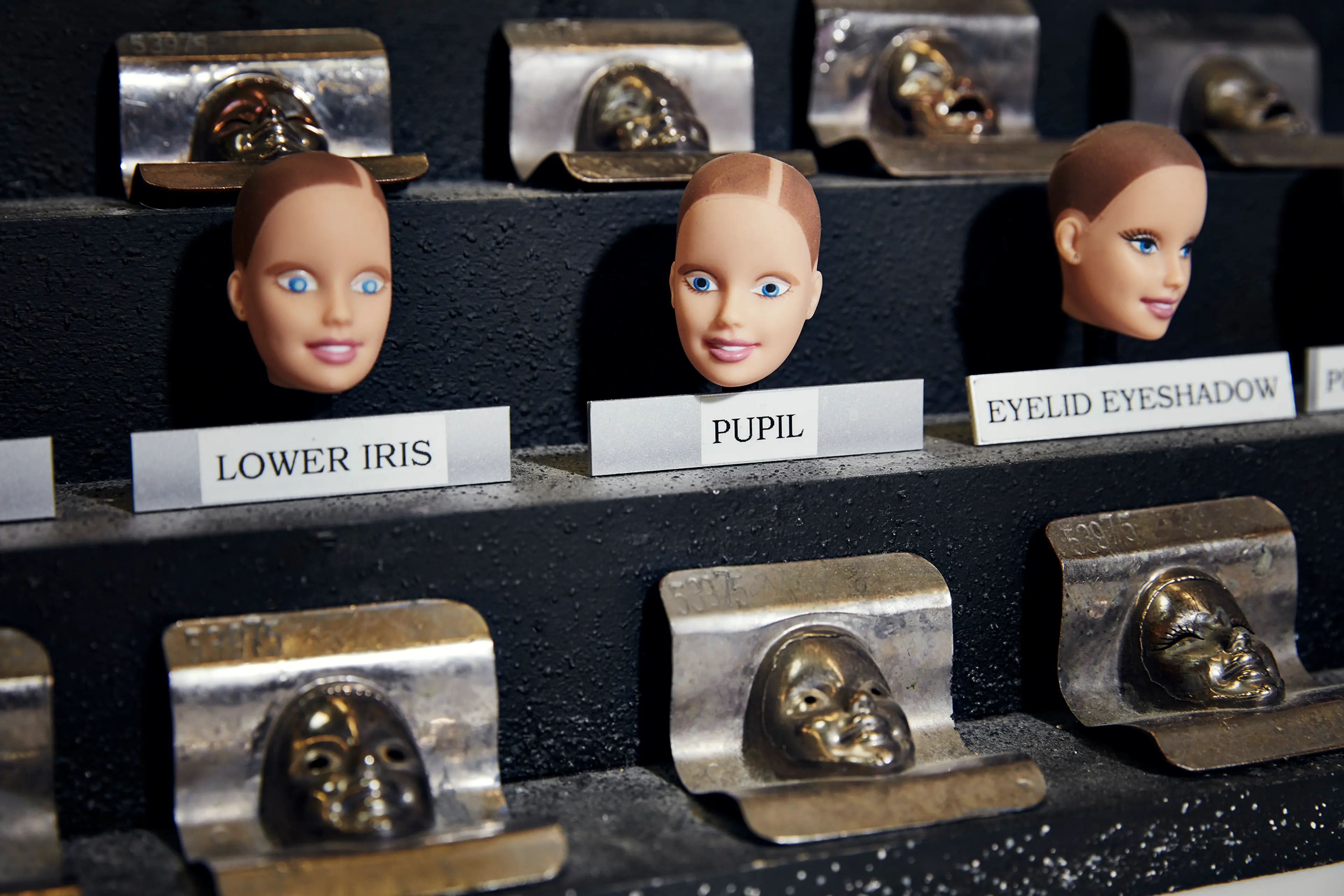 Three stages of painting Barbie's eyes.