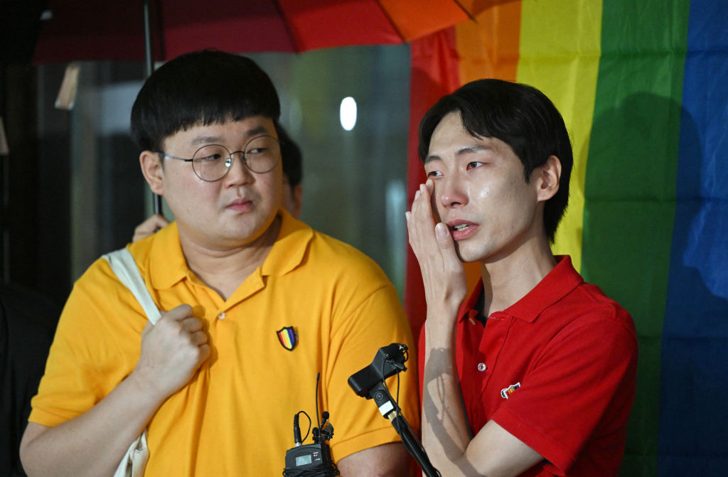 South Korean same-sex couple So Seong-wook (L) and Kim Yong-min (R) speak to reporters outside the Supreme Court building in Seoul on July 18, 2024.