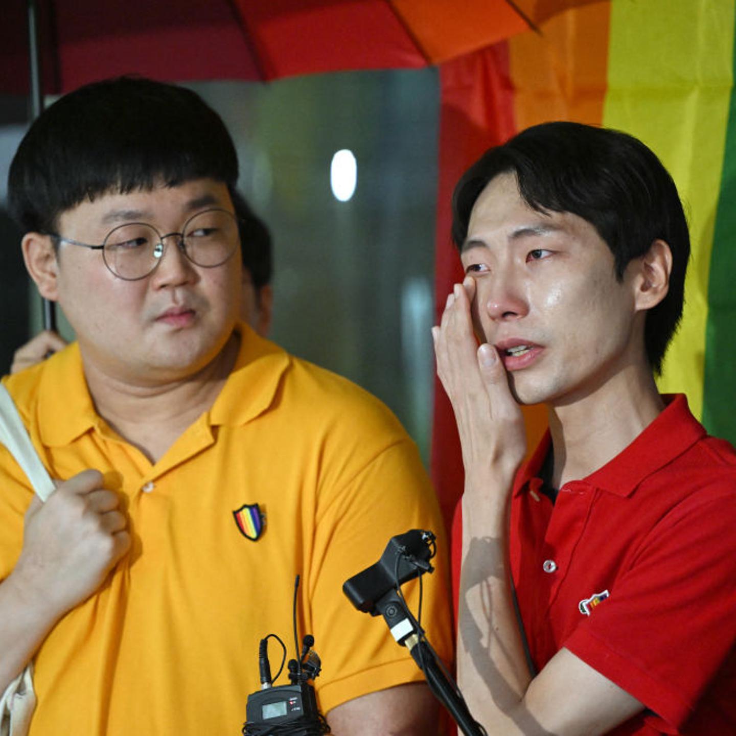 South Korean same-sex couple So Seong-wook (L) and Kim Yong-min (R) speak to reporters outside the Supreme Court building in Seoul on July 18, 2024.