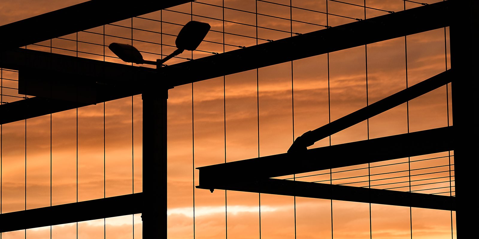 Photo of a prison gate at sunset.