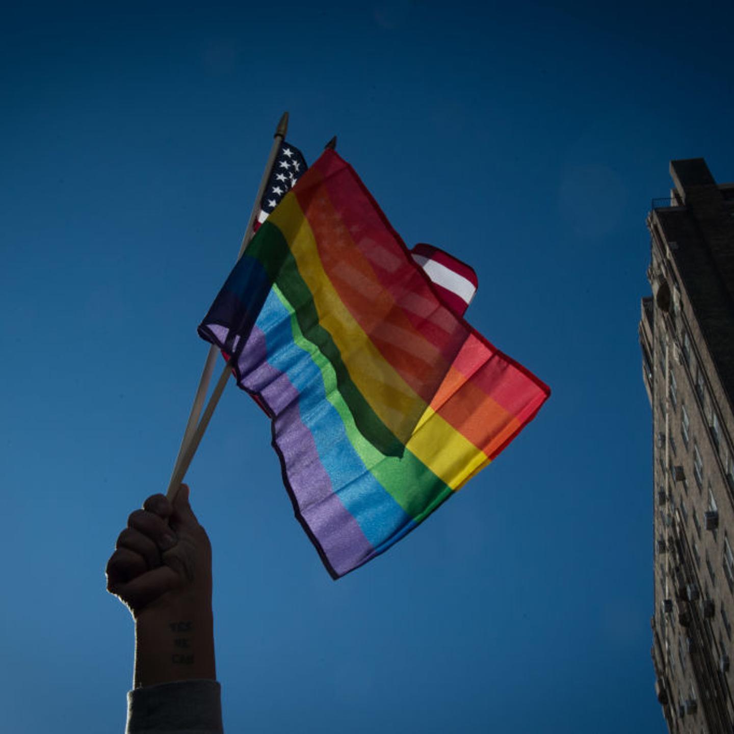 People hold flags at a rally in front of the Stonewall Inn in solidarity with immigrants, asylum seekers, refugees, and the LGBT community on Feb. 4, 2017 in New York. The demonstrators protested the policies of President Donald Trump.