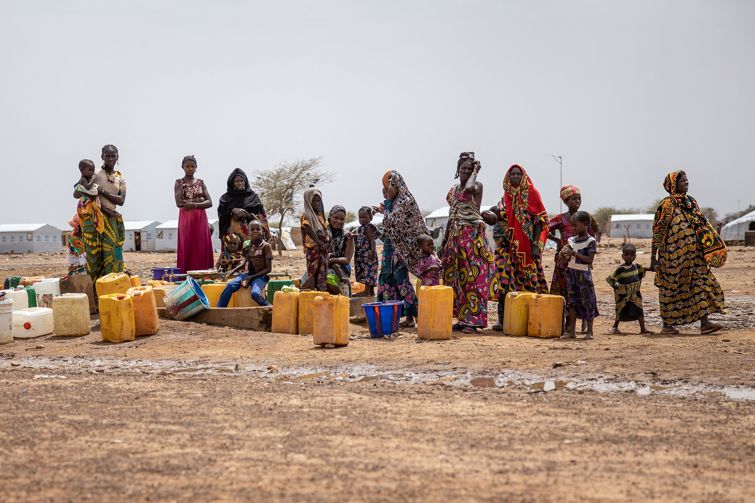 Women line up for water at Goudoubo camp in Burkina Faso, on June 20. The camp is sheltering thousands of Malians who have fled jihadist violence in the region.