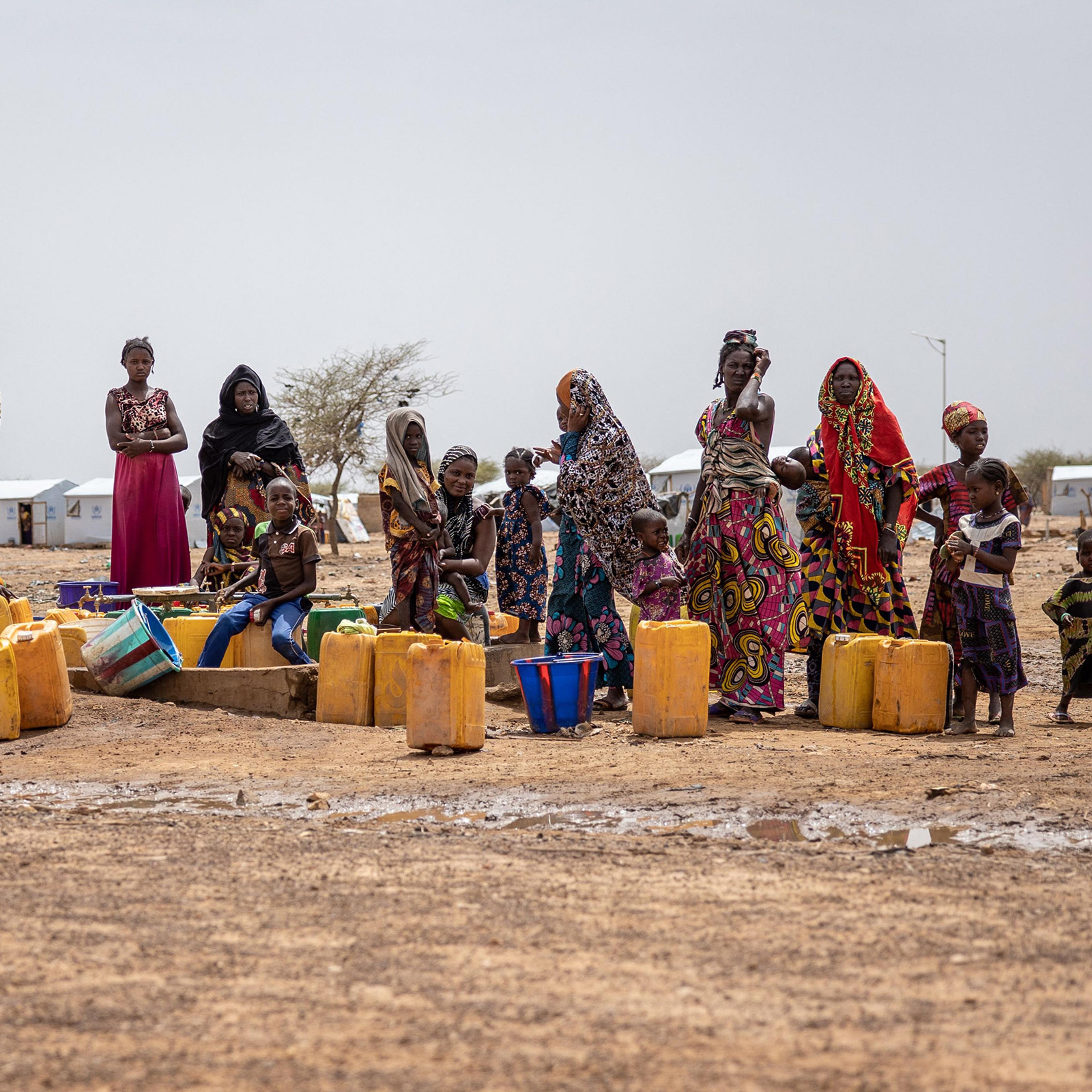 Women line up for water at Goudoubo camp in Burkina Faso, on June 20. The camp is sheltering thousands of Malians who have fled jihadist violence in the region.