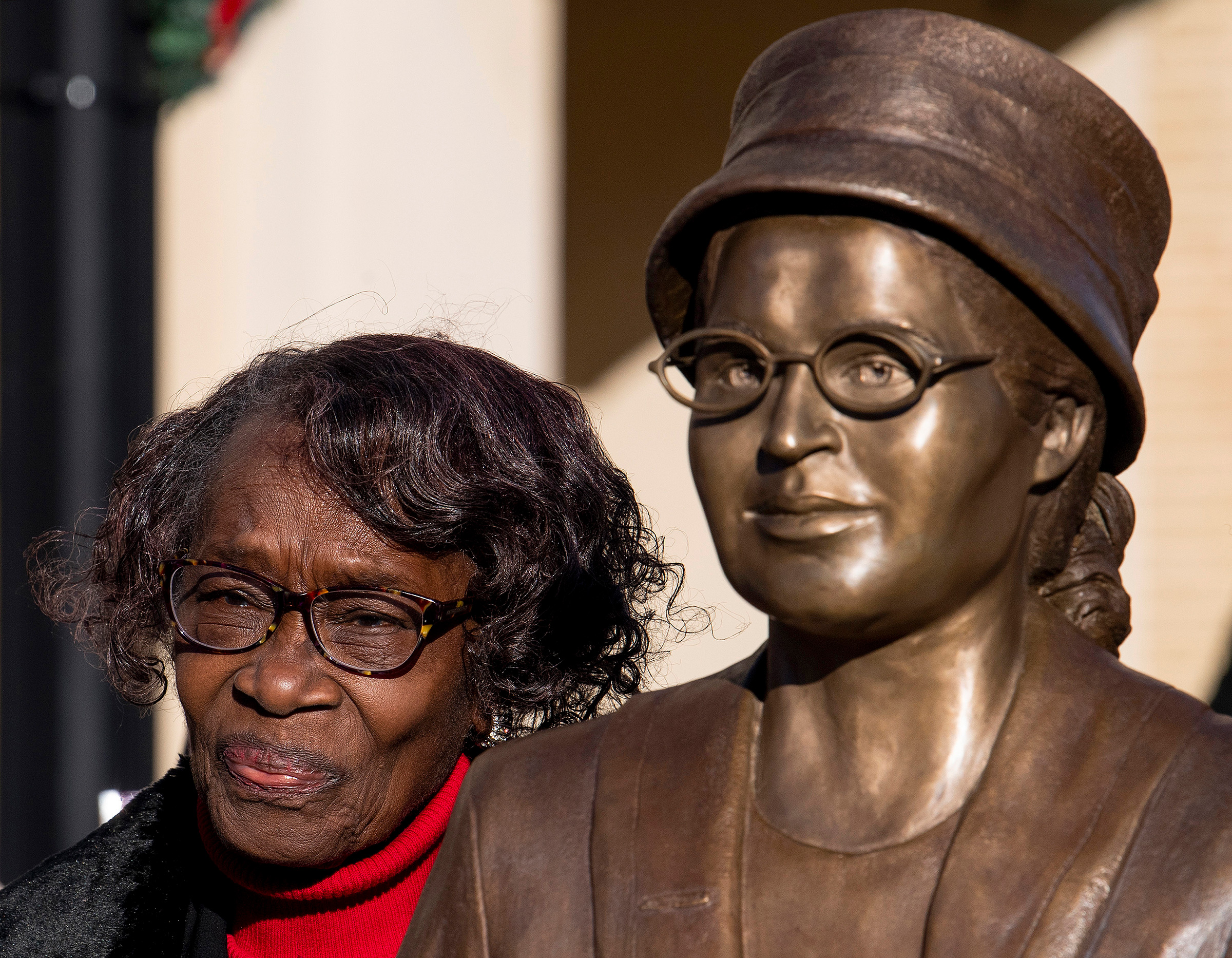 Mary Louise Smith, a plaintiff in the Browder vs. Gayle case that desegregated buses in Montgomery, stands beside the Rosa Parks statue after its unveiling event in downtown Montgomery, Ala., on Dec. 1, 2019, the anniversary of her arrest for not giving 