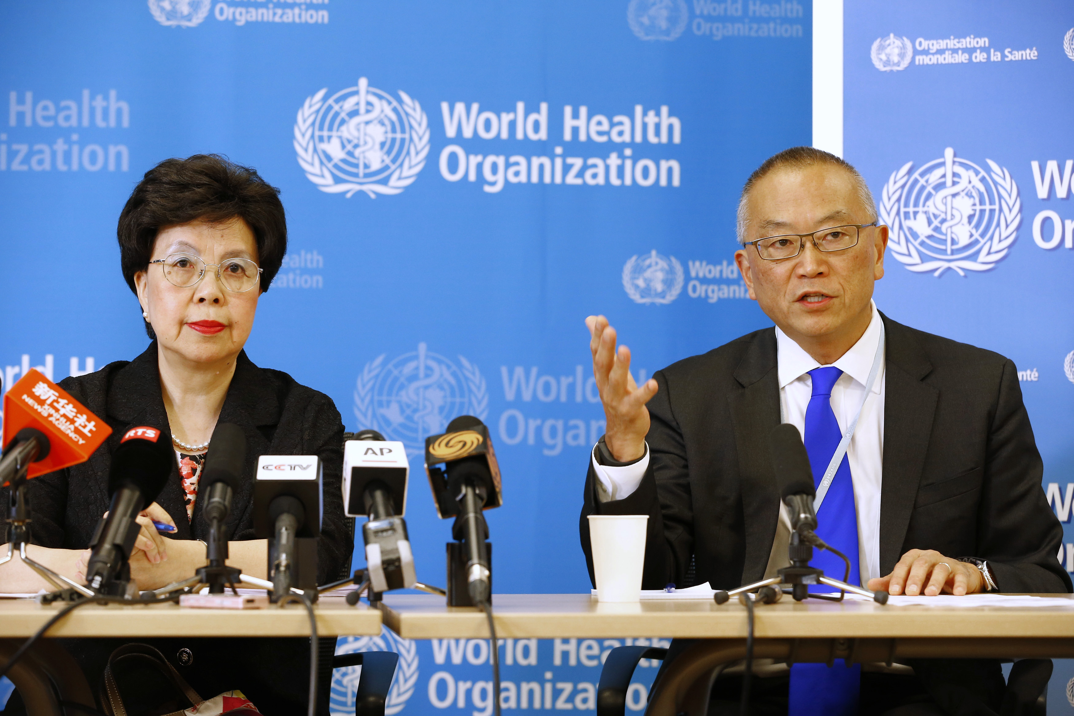 WHO Director-General Margaret Chan sits next to Fukuda, WHO's assistant director general for health security, as he addresses the media in Geneva