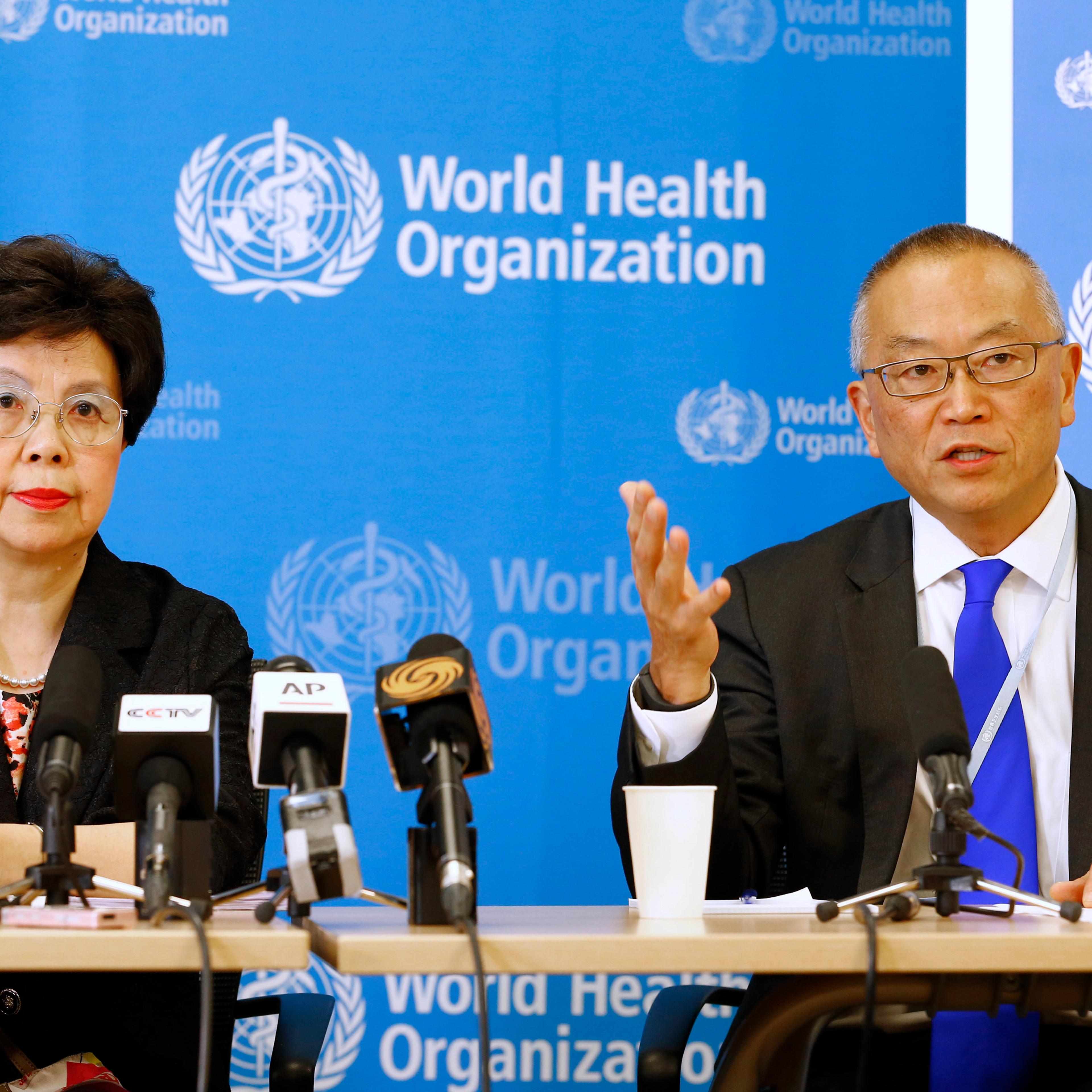 WHO Director-General Margaret Chan sits next to Fukuda, WHO's assistant director general for health security, as he addresses the media in Geneva