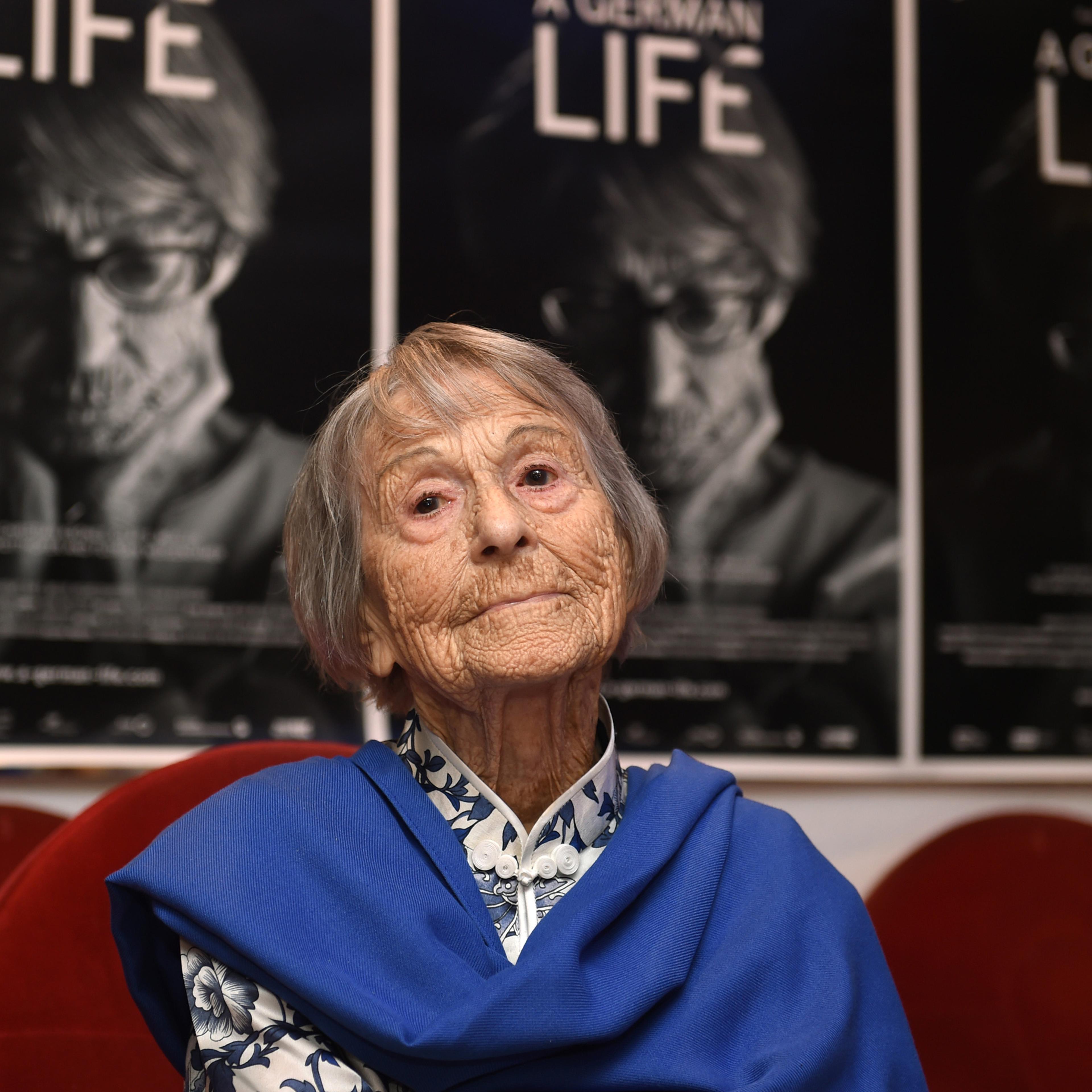 Brunhilde Pomsel, former secretary of Nazi propaganda chief Joseph Goebbels, sits on a cinema chair in front of posters for the movie "A German life" in a cinema in Munich, southern Germany, on June 29, 2016.