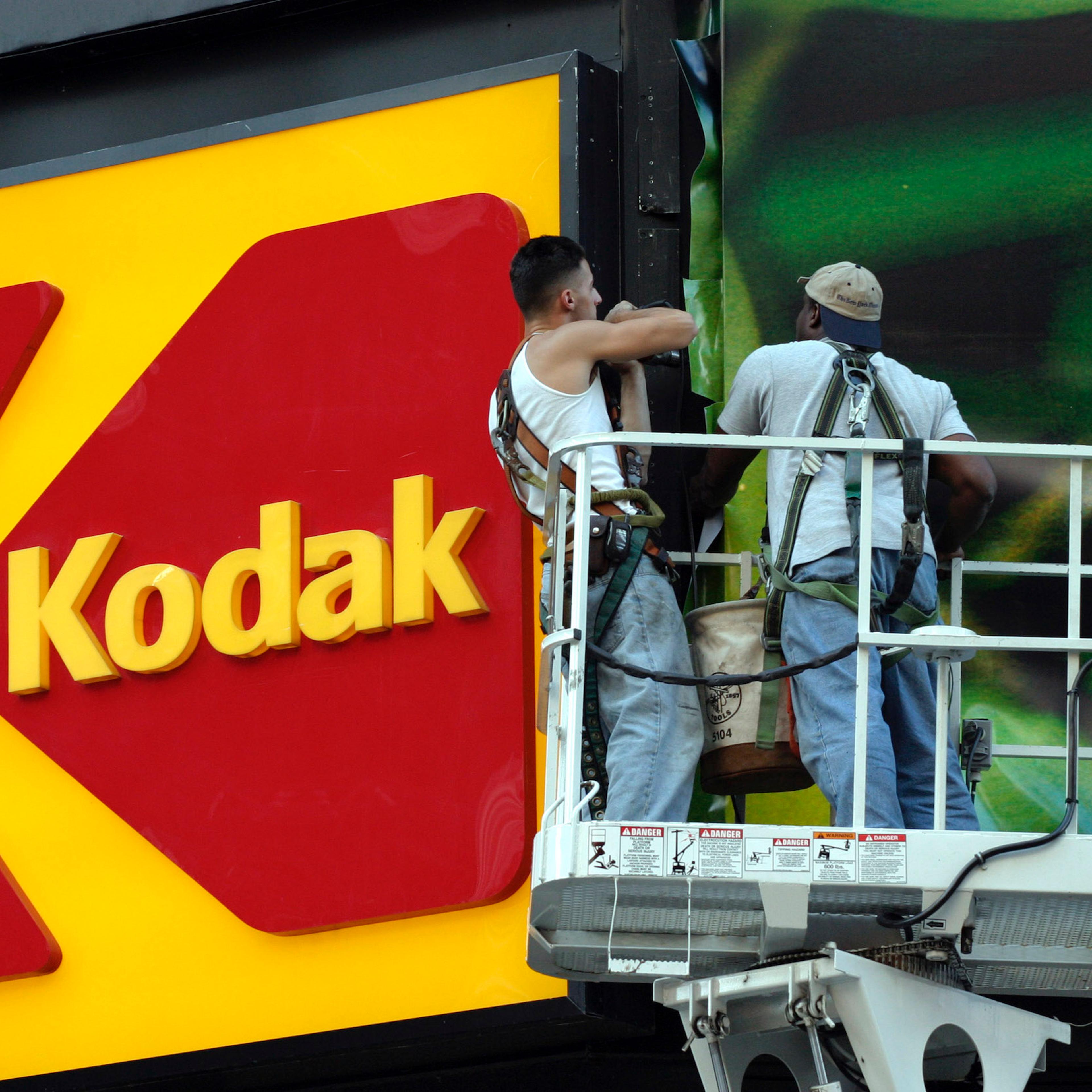 Workers stand near the KODAK billboard at Times Square, New York City.